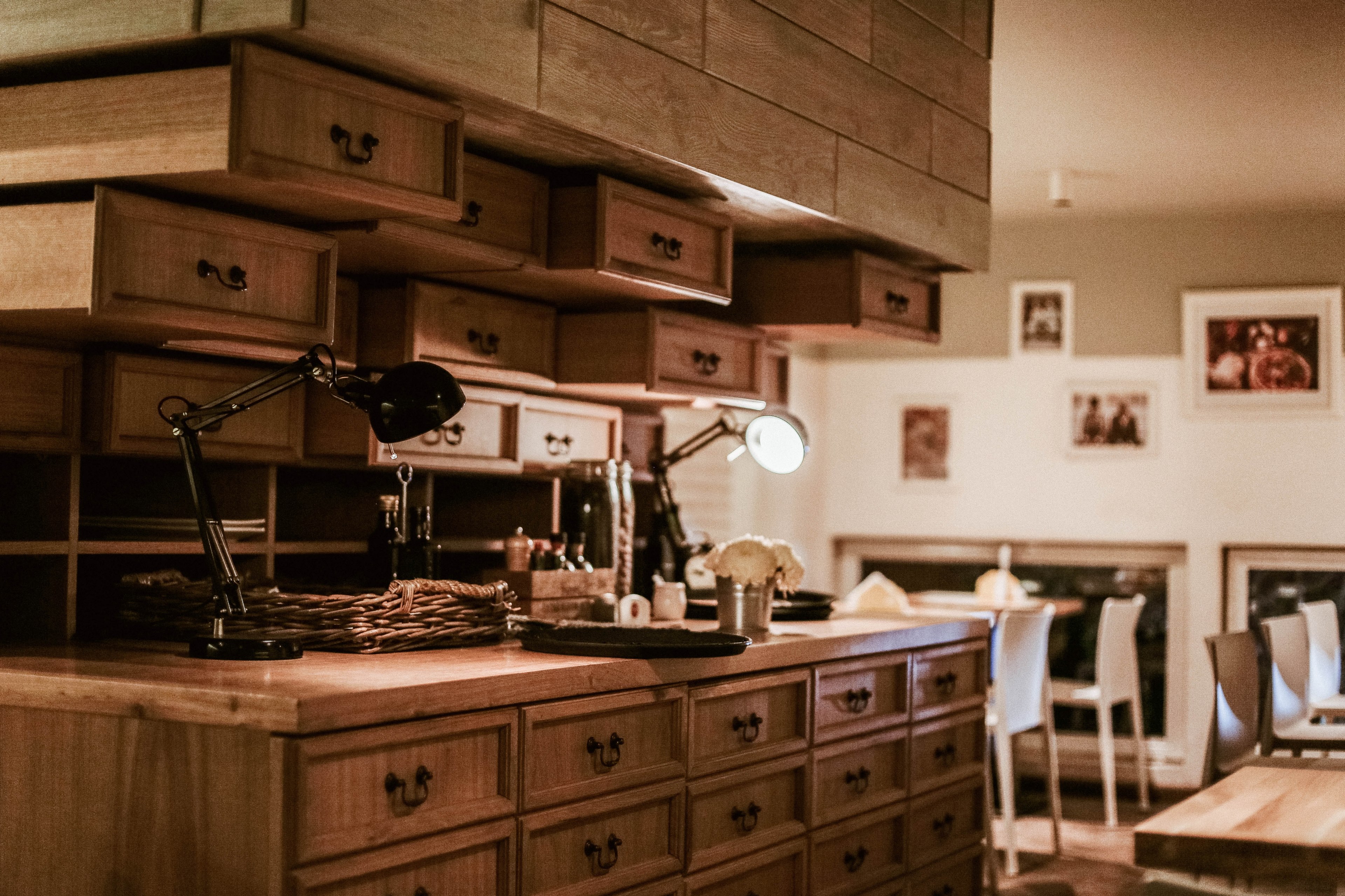 rows of wooden drawers surrounding a small workplace in middle of well lit room, well lit workplace 4k, HD Wallpaper