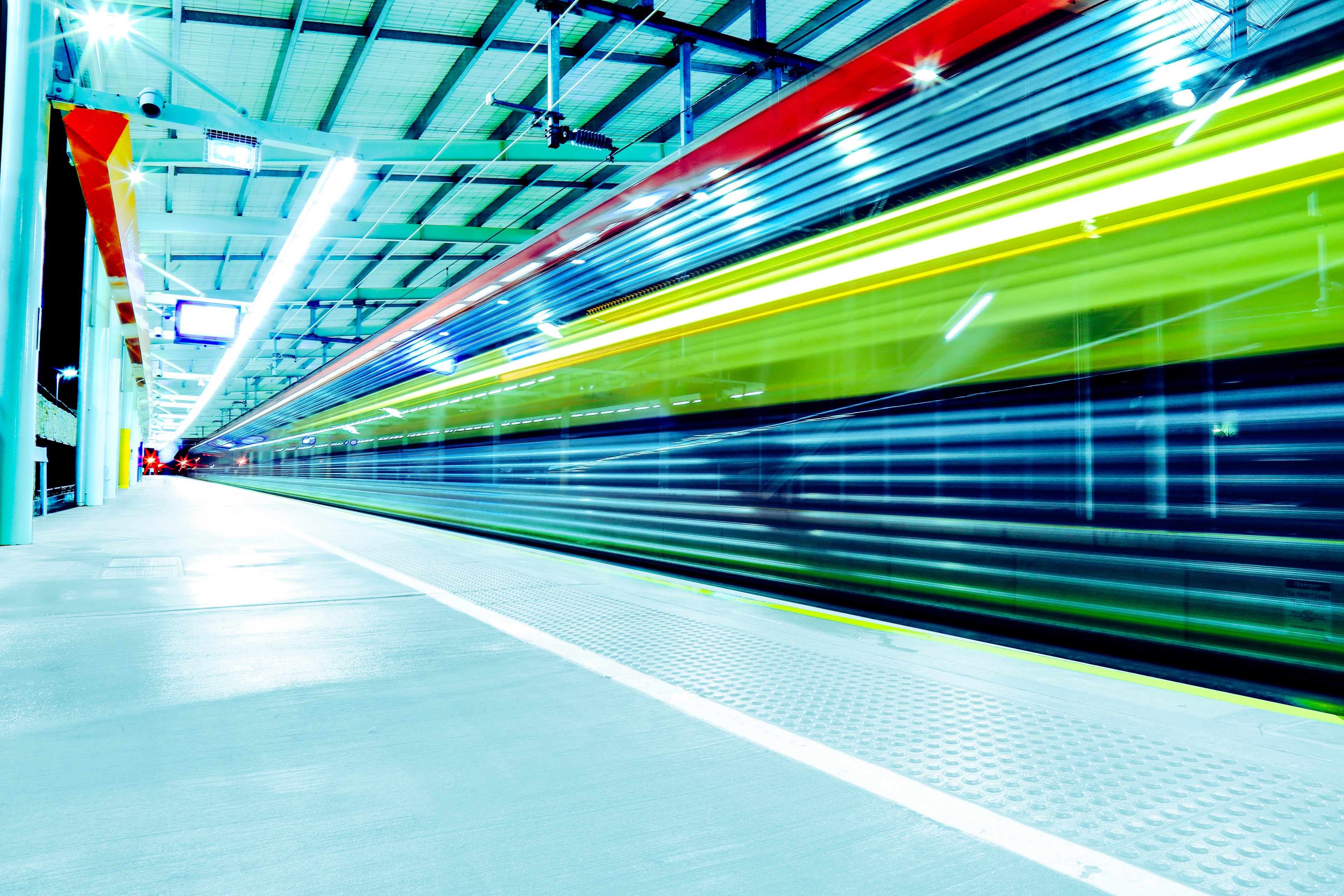 a long exposure shot of a railway platform with colorful light trails from passing trains, light trails on a railway station 4k, HD Wallpaper
