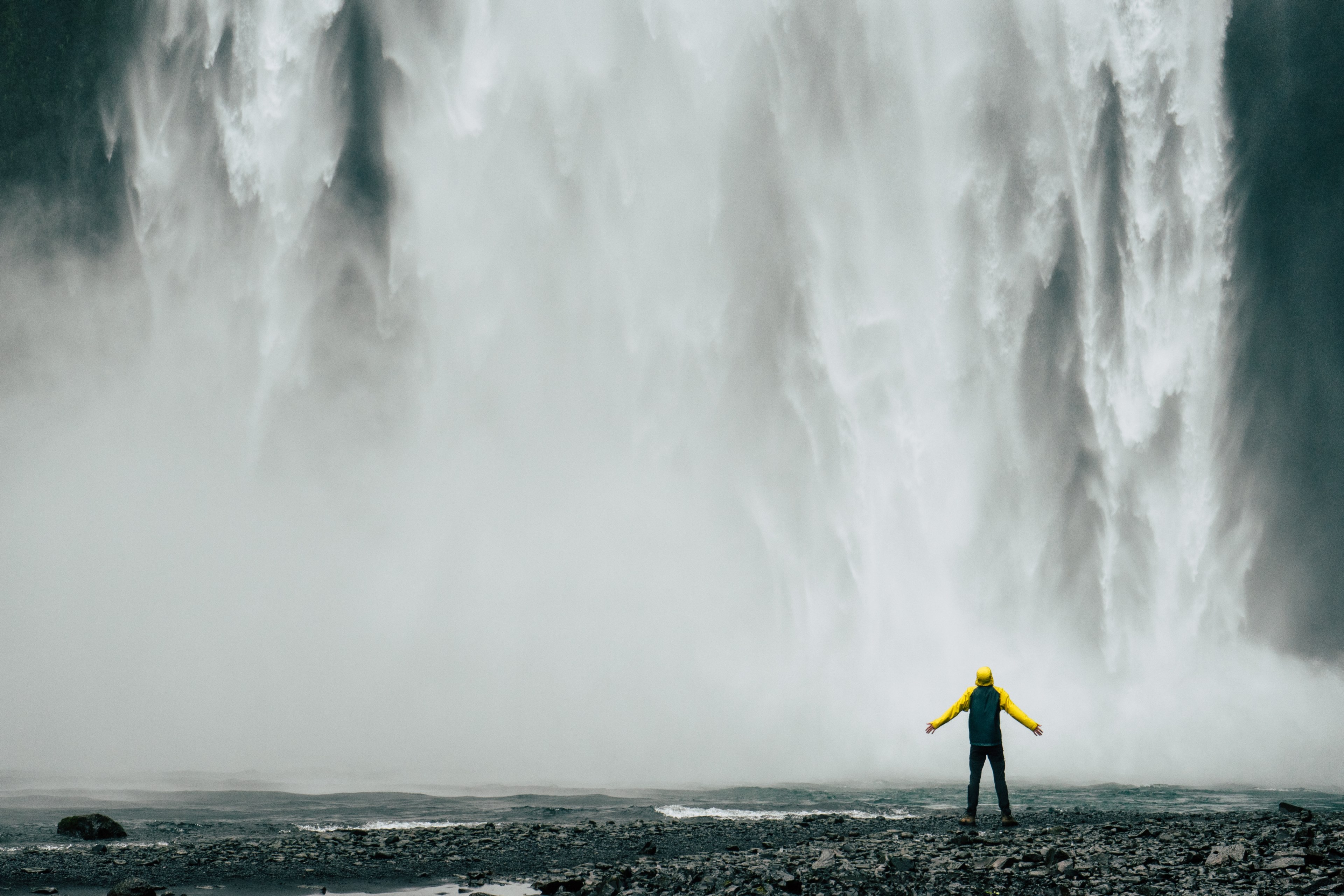 person with outstretched arms basks in the mist of a waterfall, at the waterfall 4k, HD Wallpaper