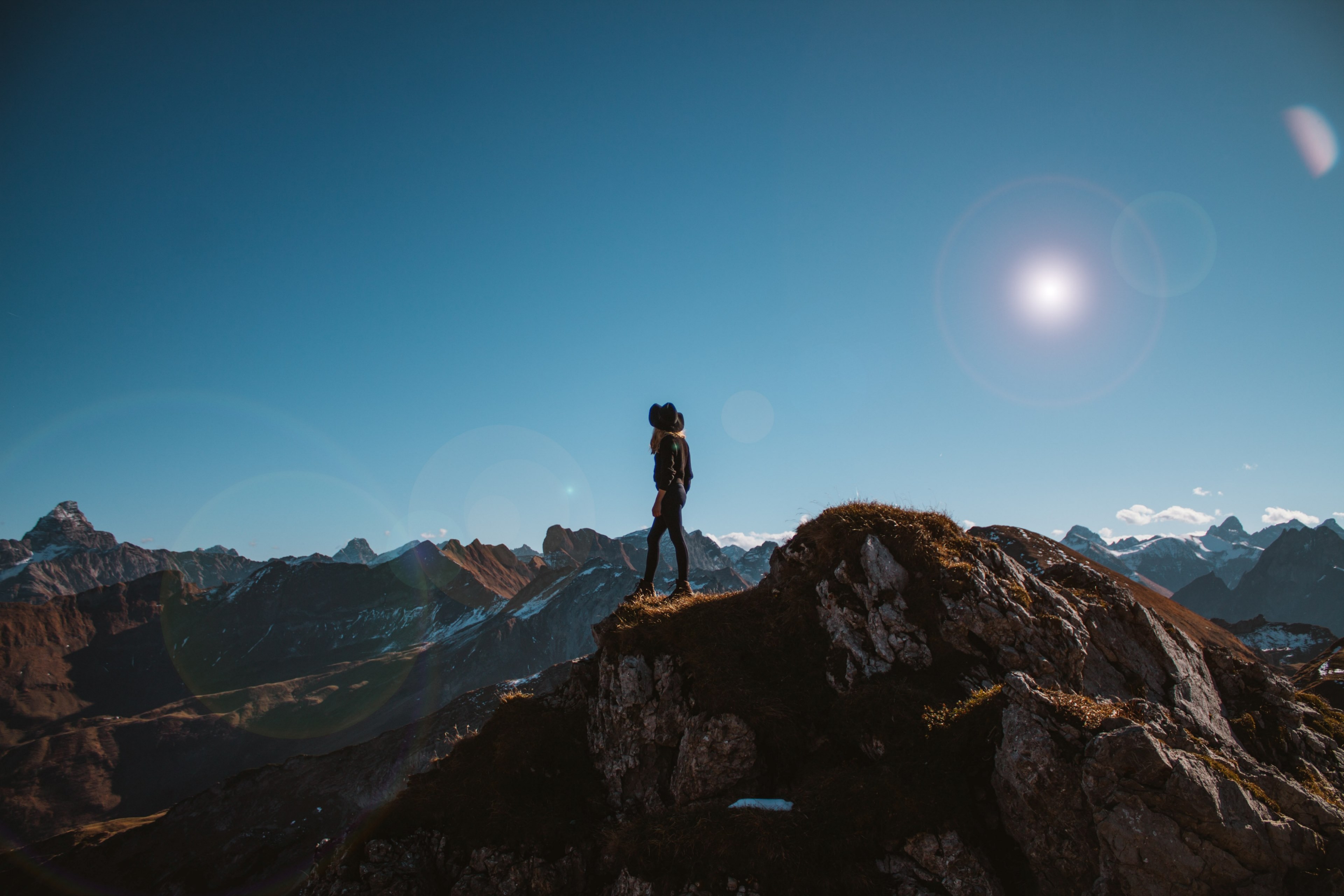 a woman wearing a black hat and black clothing standing on the top of a mountaintop in nebelhorn, nebelhorn hiker 4k, HD Wallpaper