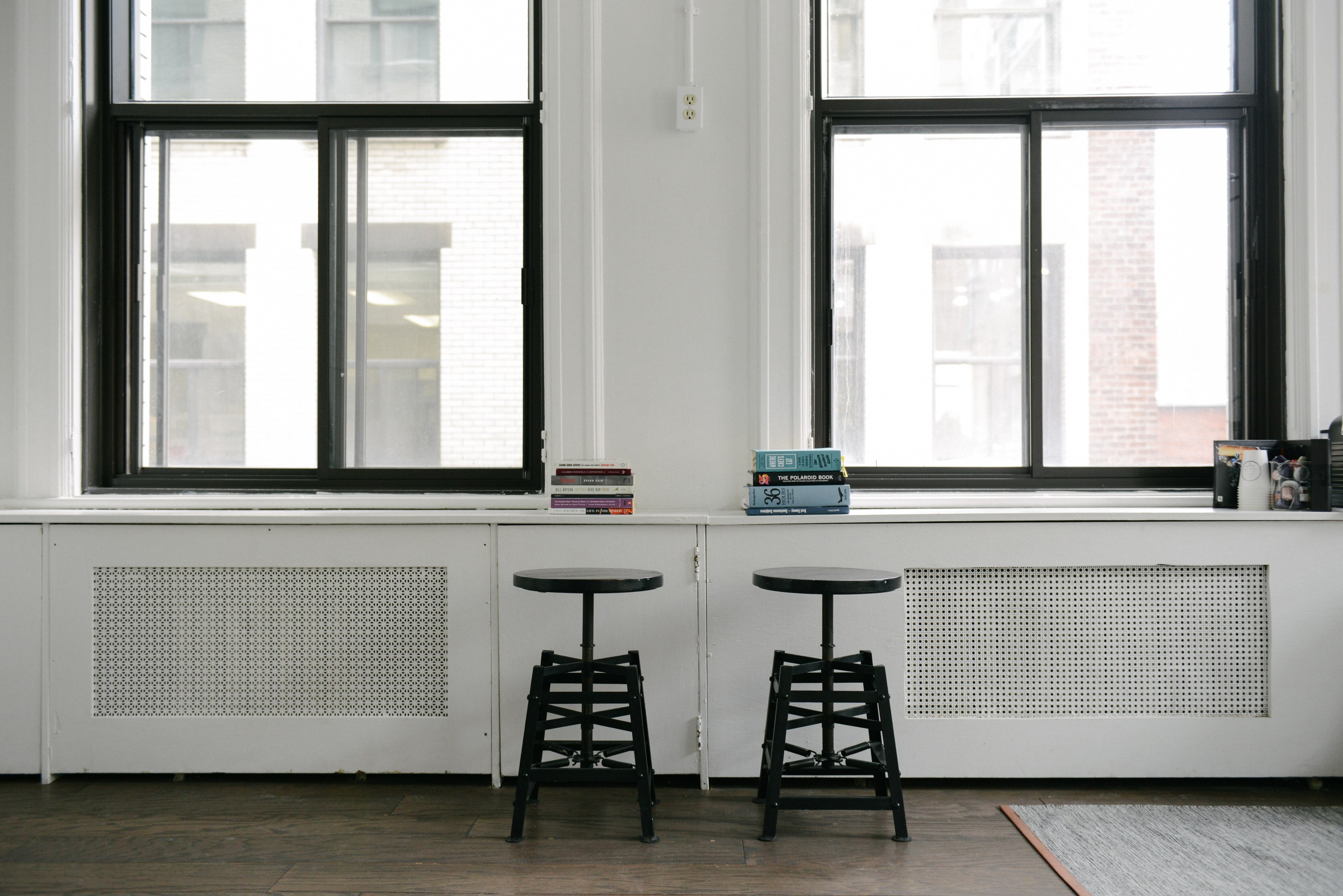 two stacks of books on a windowsill with two stools next to it, book stacks on a windowsill 4k, HD Wallpaper