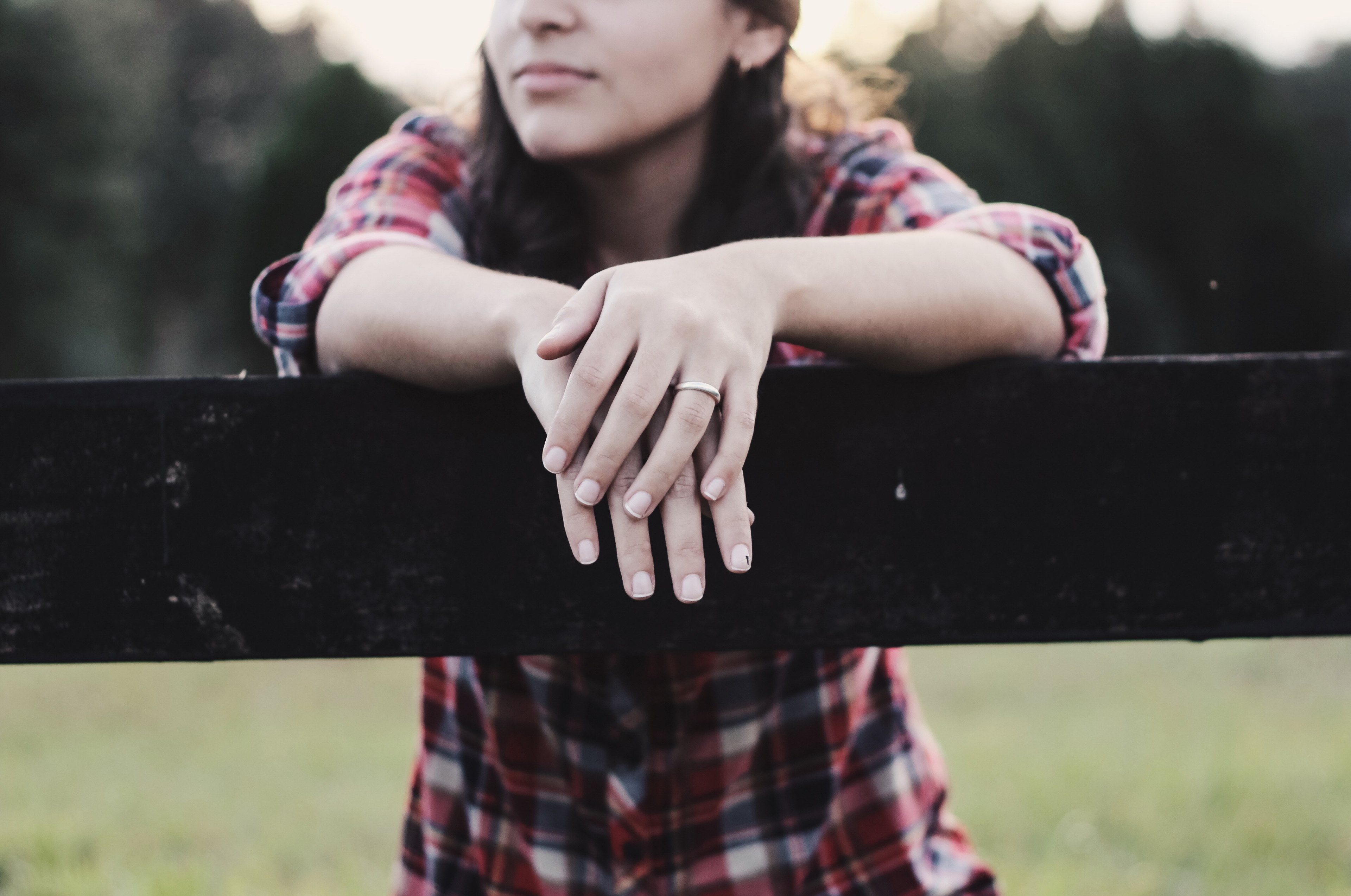 woman wearing flannel stands over wooden post with dark lighting, woman poses over wooden fence 4k, HD Wallpaper