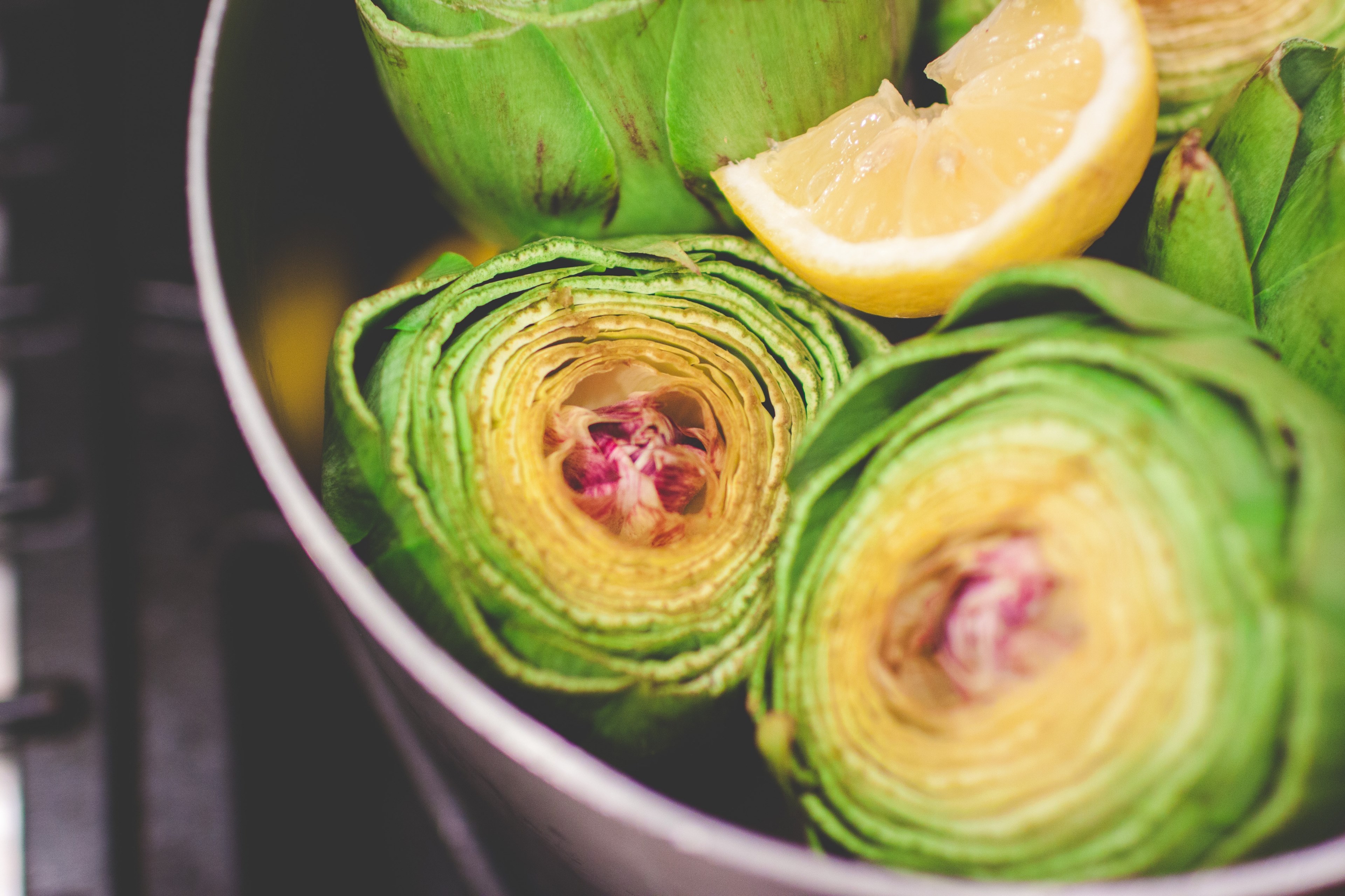 sliced artichokes with lemon boiling in a pot, artichokes for dinner 4k, HD Wallpaper