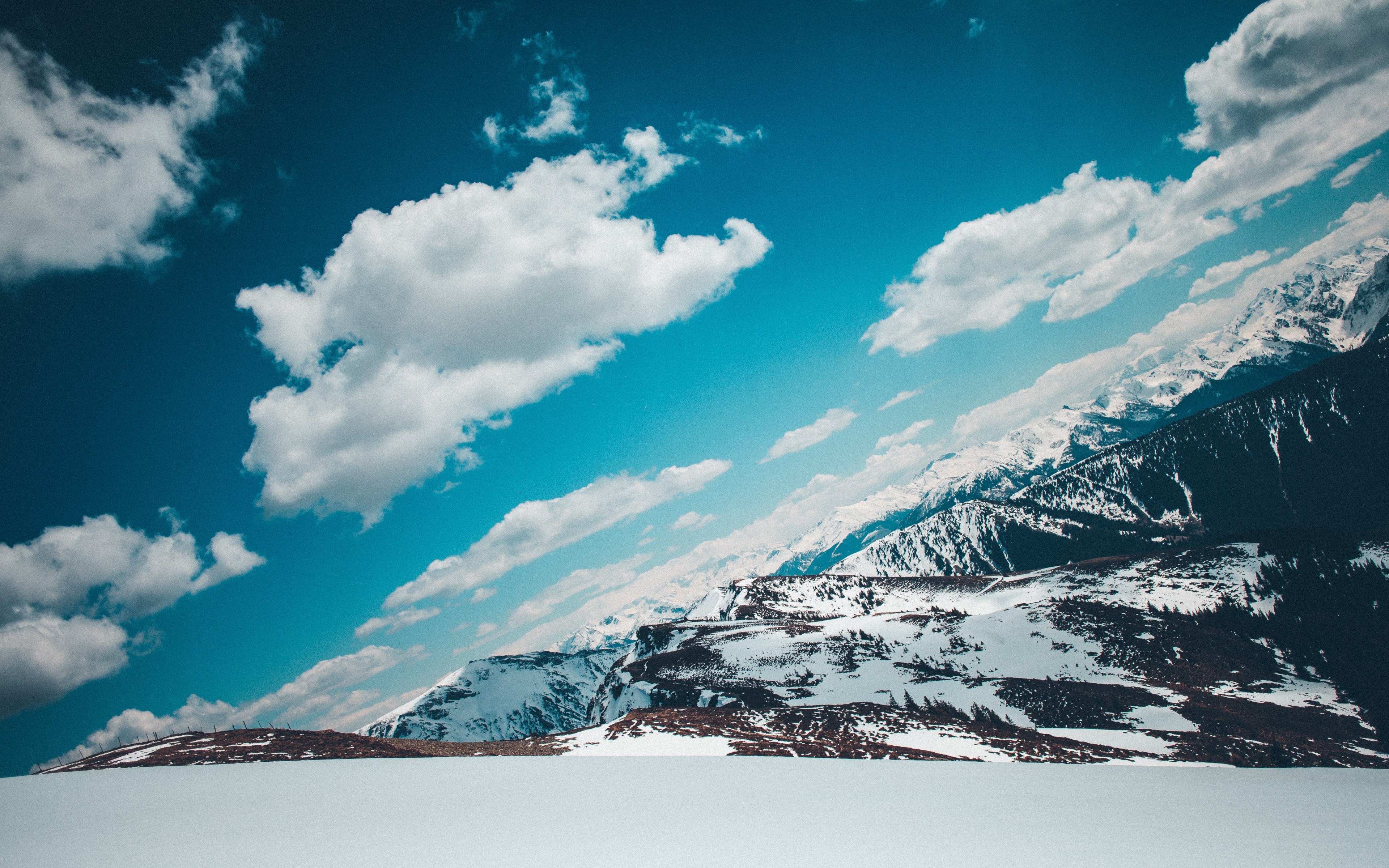 an angular shot of snow capped mountains under fluffy clouds, schwalbenwand 4k, HD Wallpaper