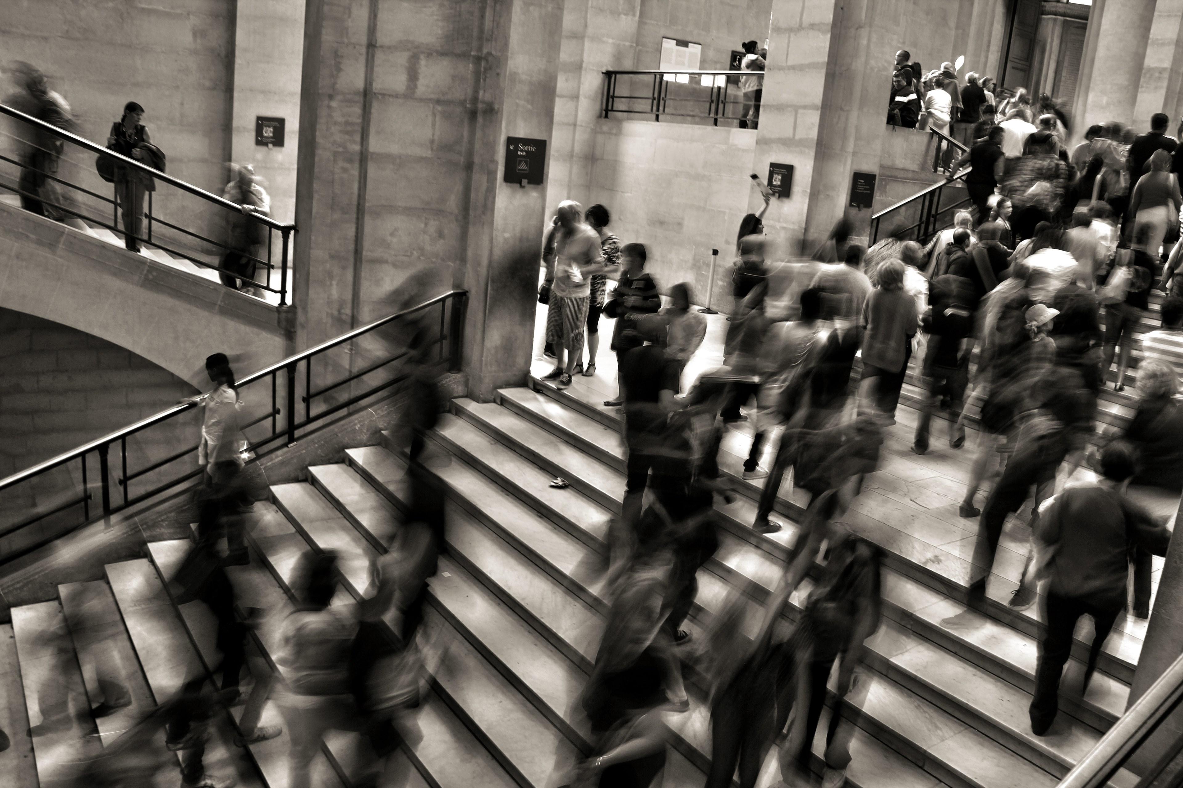 a desaturated long exposure shot of people crowding on stairs in a large public building, busy stairs in large building 4k, HD Wallpaper