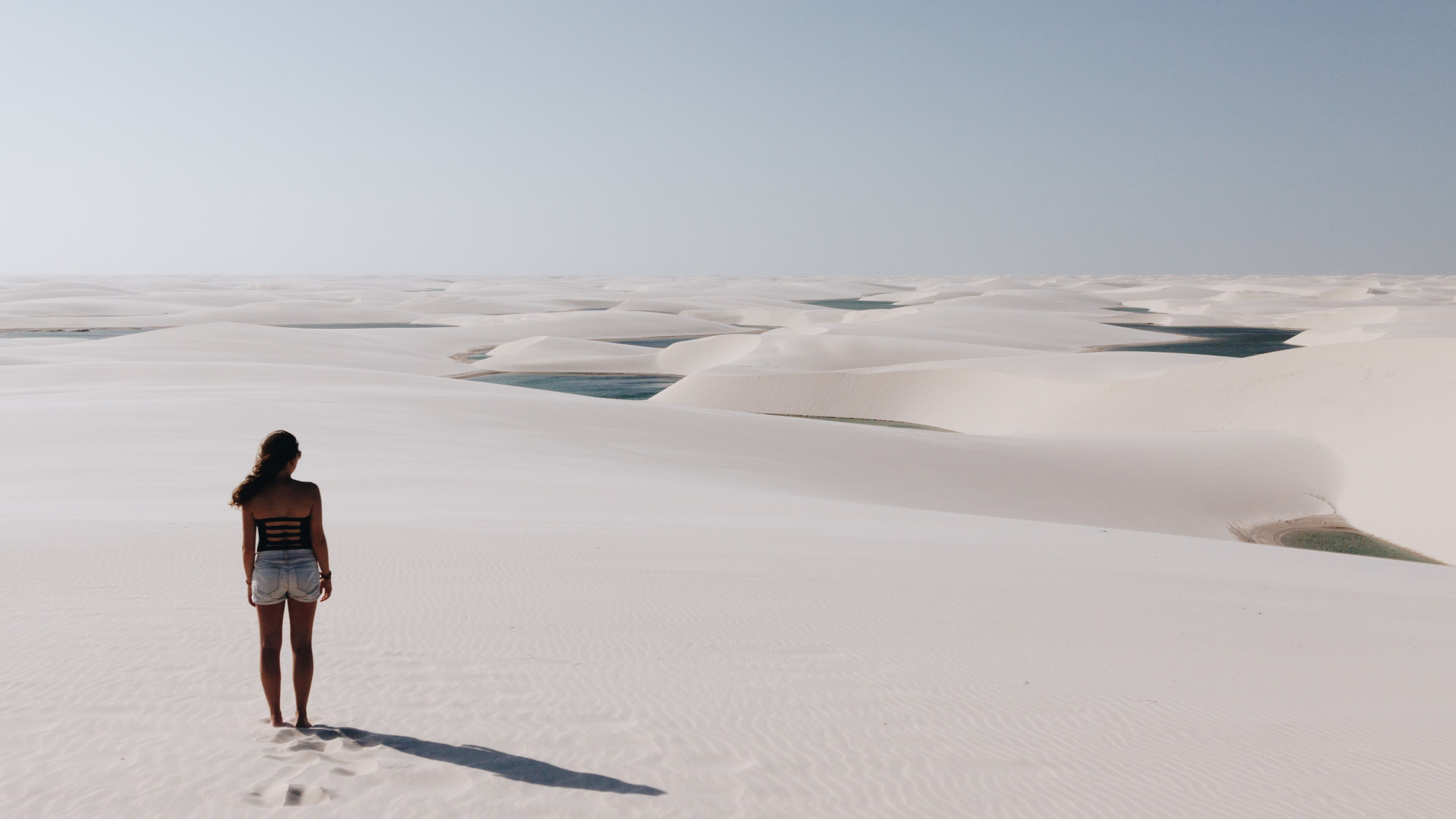 a woman walking in white sand with dunes nearby, _woman staring at sand dunes 4k, HD Wallpaper