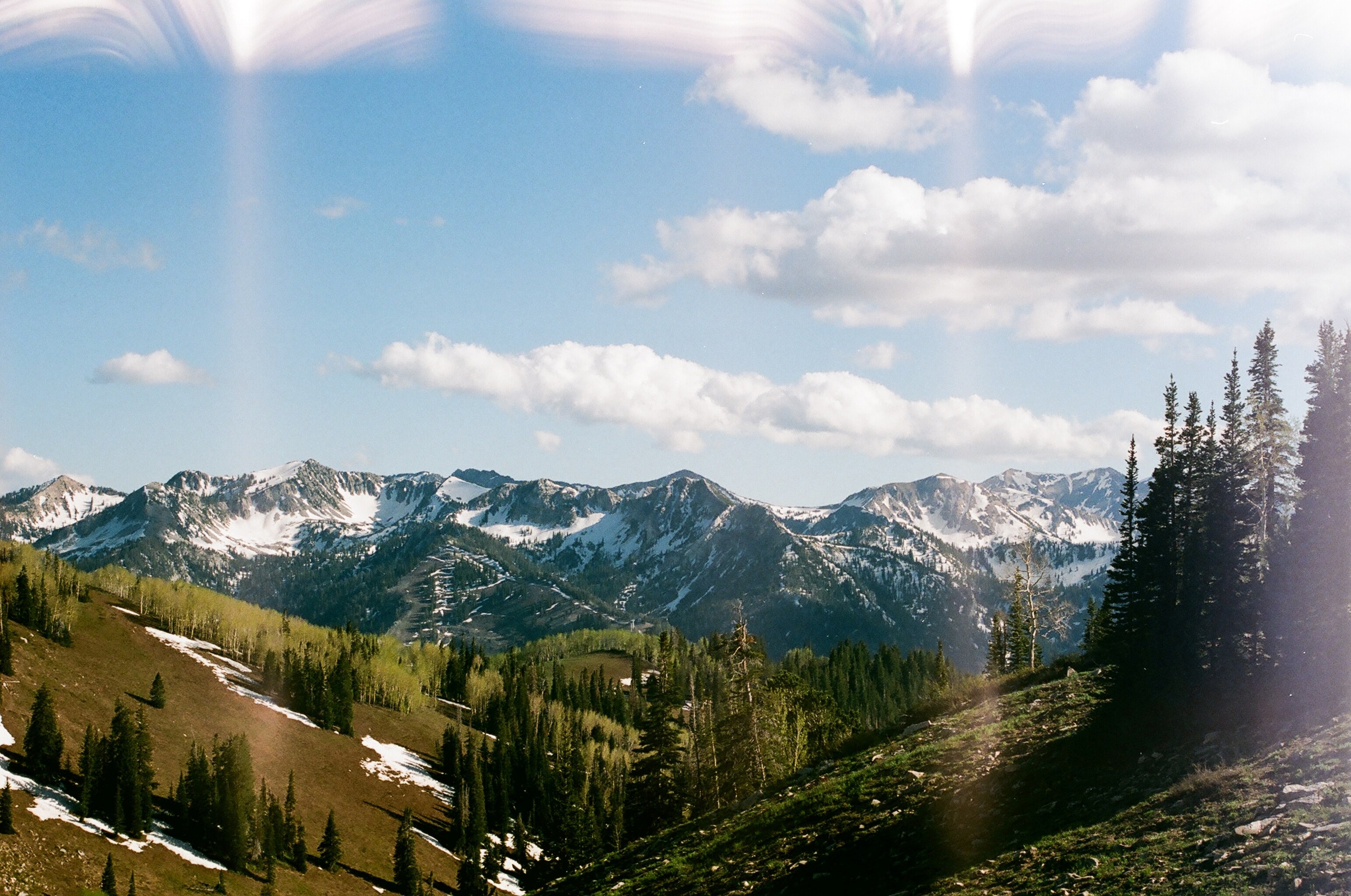 a panorama of a wooded valley with snow capped mountains in the back, mountain valley in the spring 4k, HD Wallpaper