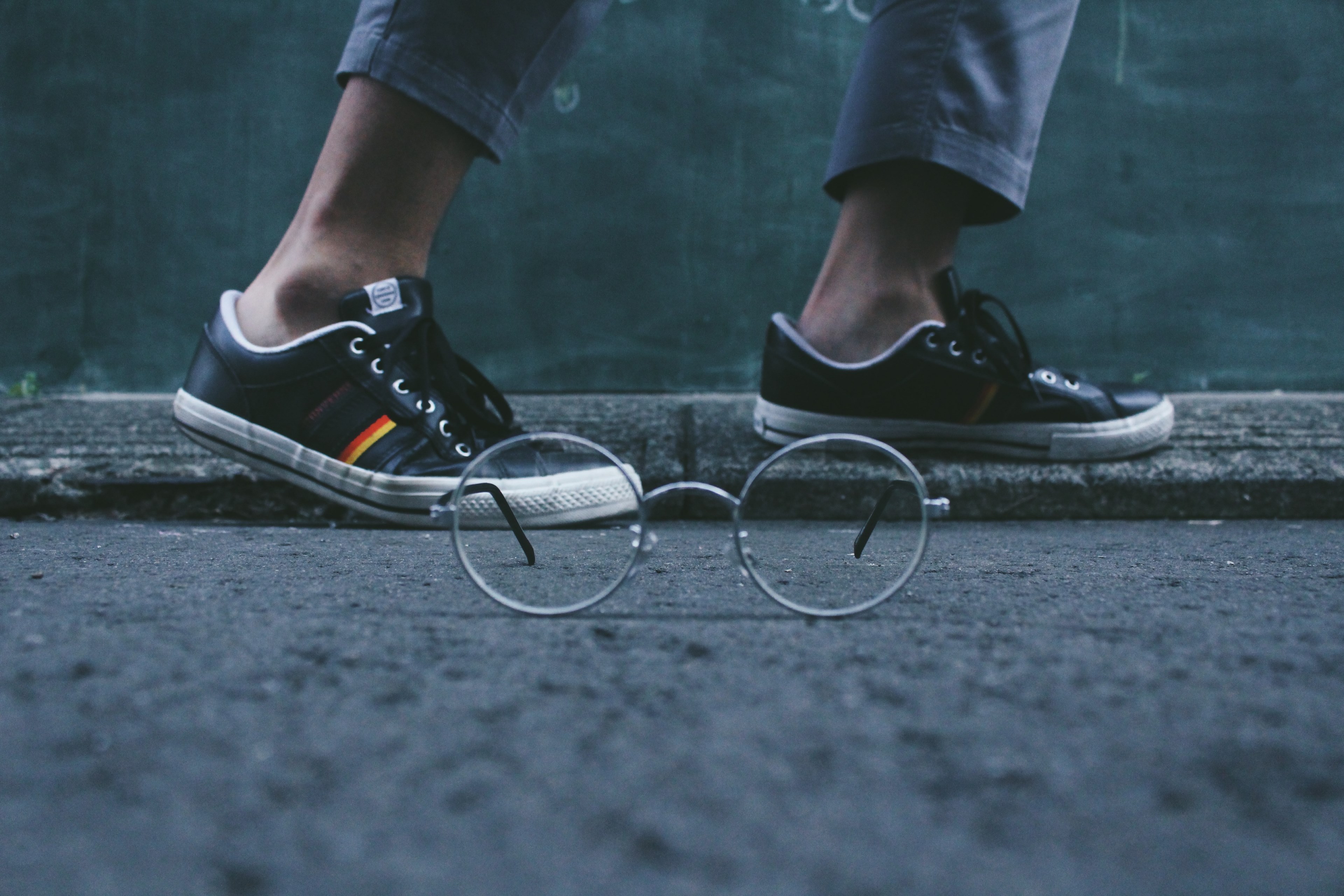 a pair of glasses on the asphalt next to a persons feet in sneakers, glasses on asphalt 4k, HD Wallpaper