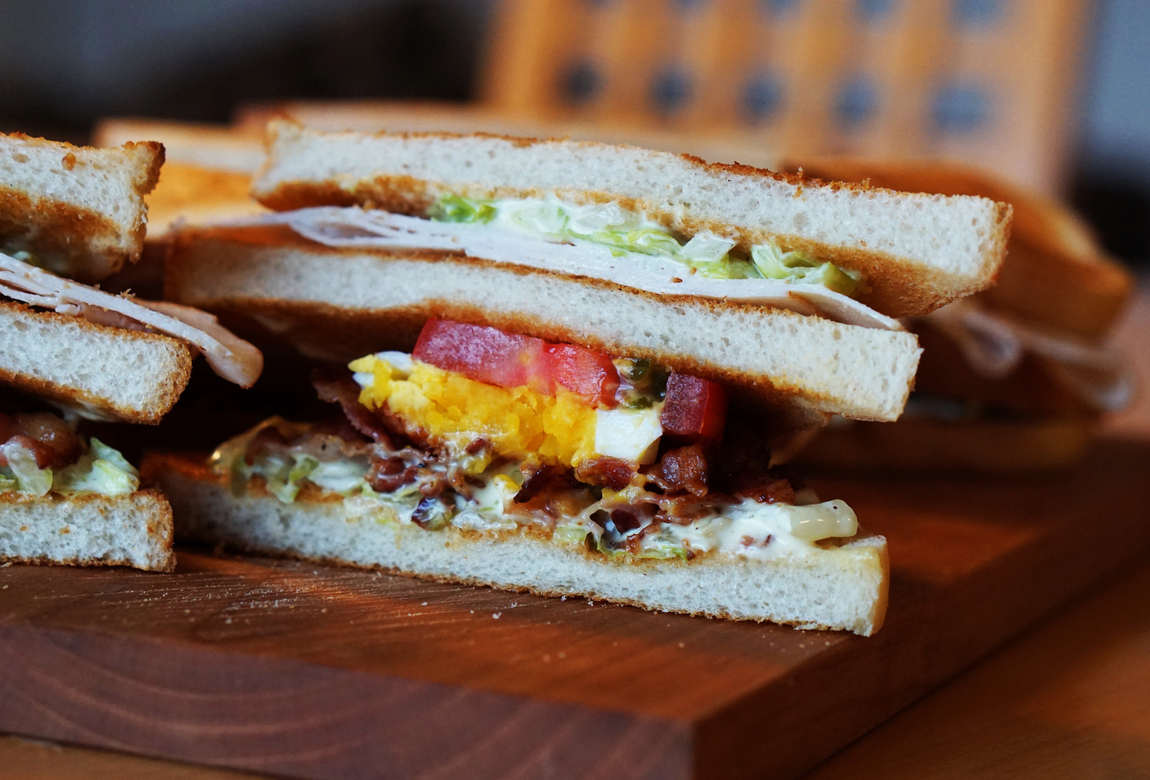 a club sandwich with tomato lettuce egg bacon mayonnaise and turkey on a wooden plate, just a club sandwich 4k, HD Wallpaper