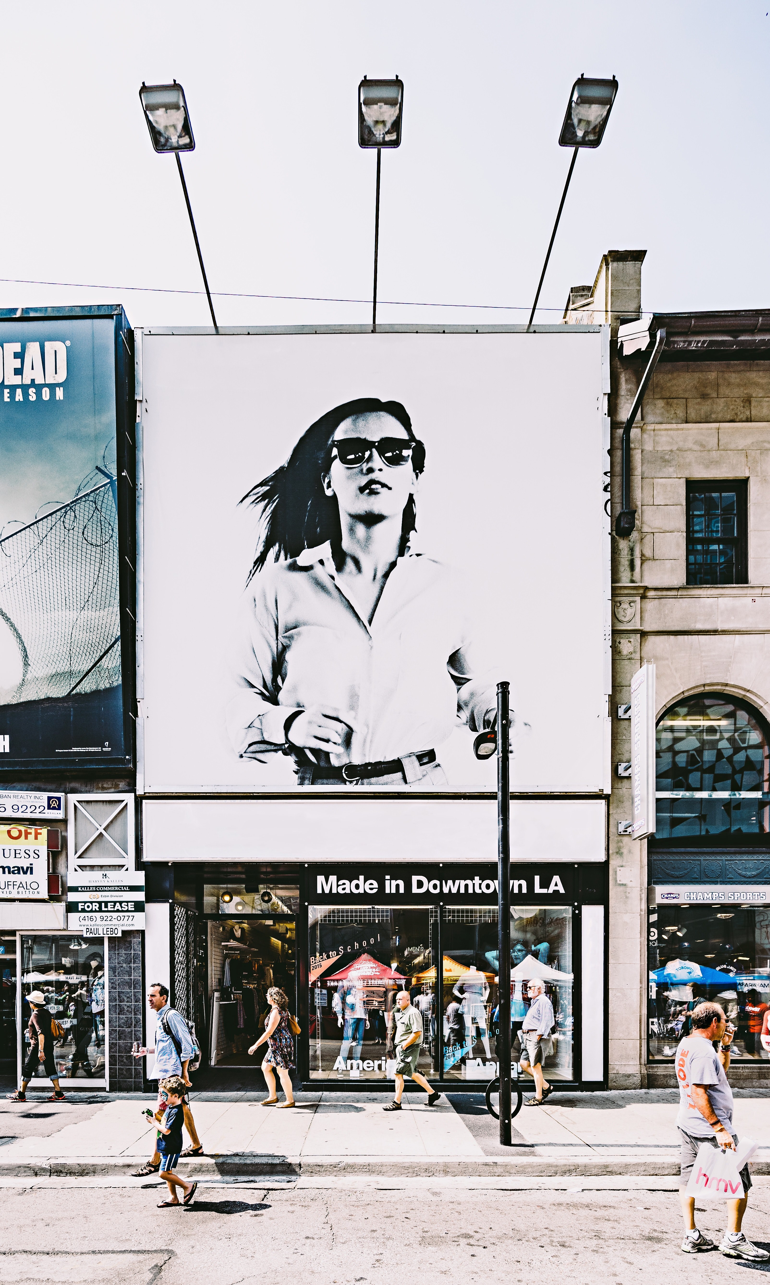 a large advertisement with an elegant woman in sunglasses over a storefront, storefront with a billboard 4k, Phone HD Wallpaper