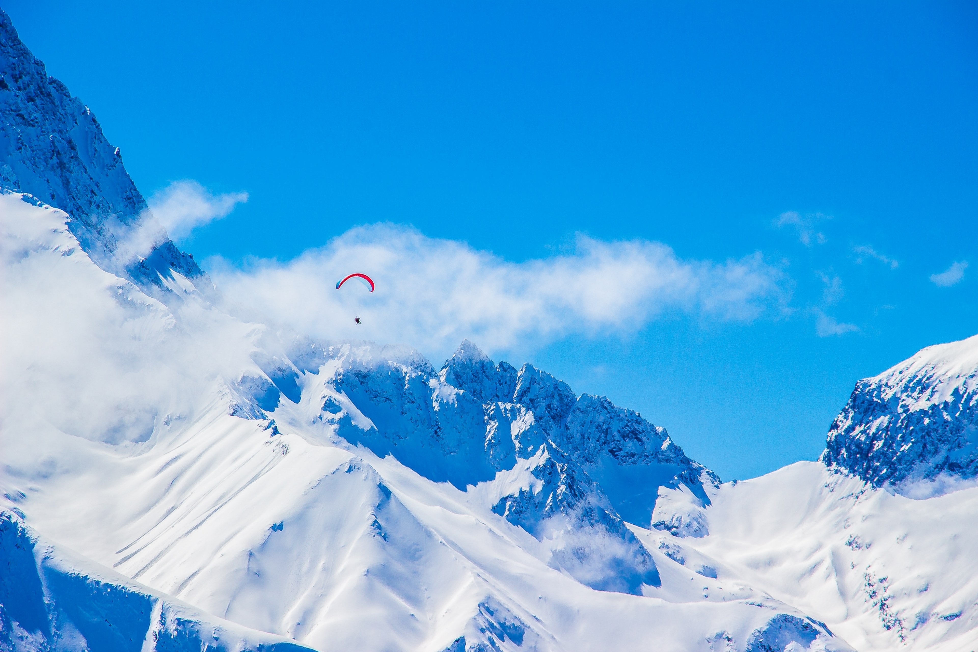 a paraglider gliding over les 2 alpes snowy mountainside, i believe i can 4k, HD Wallpaper