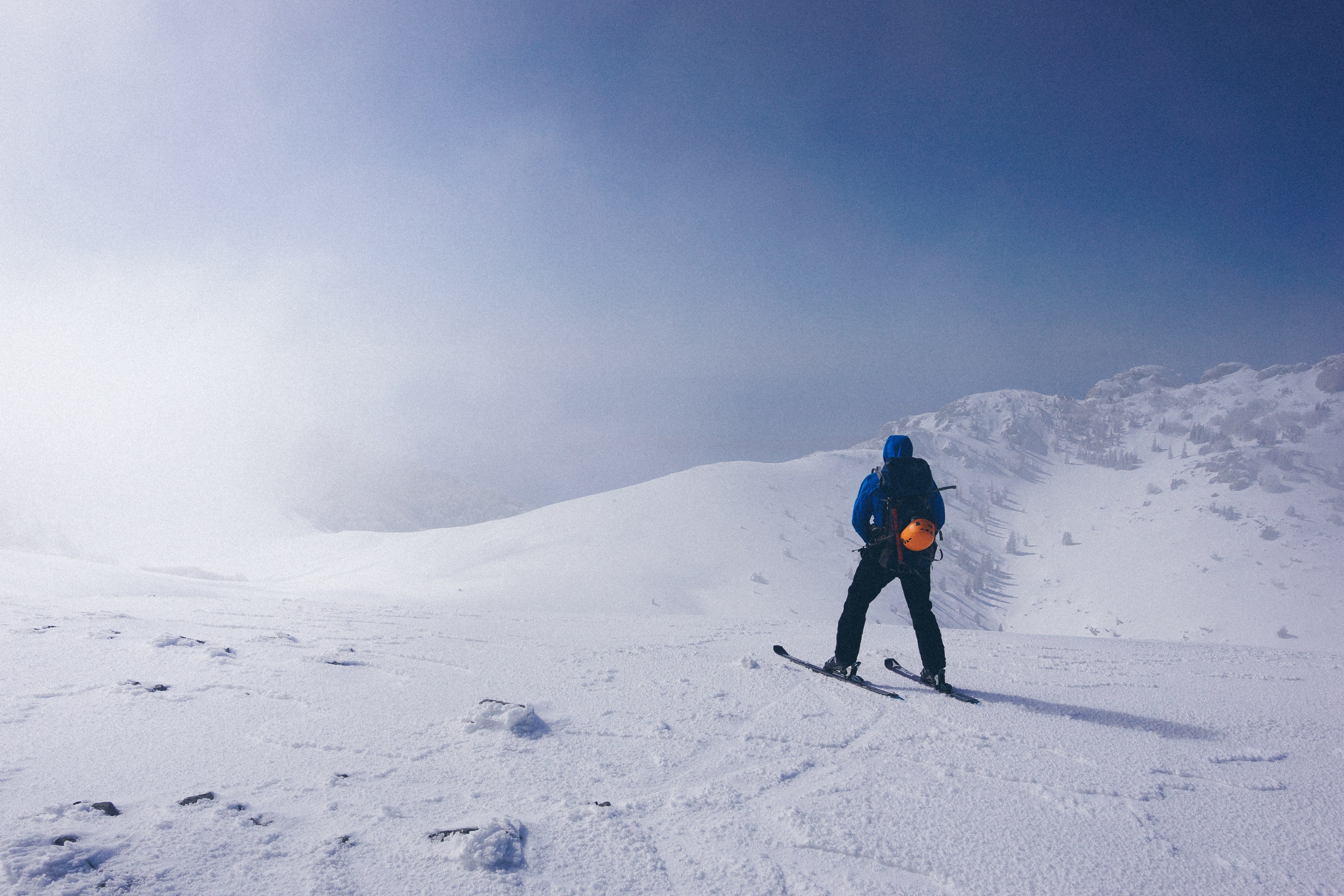 a man walking in skis on a slight slope near medium sized mountains, blown 4k, HD Wallpaper