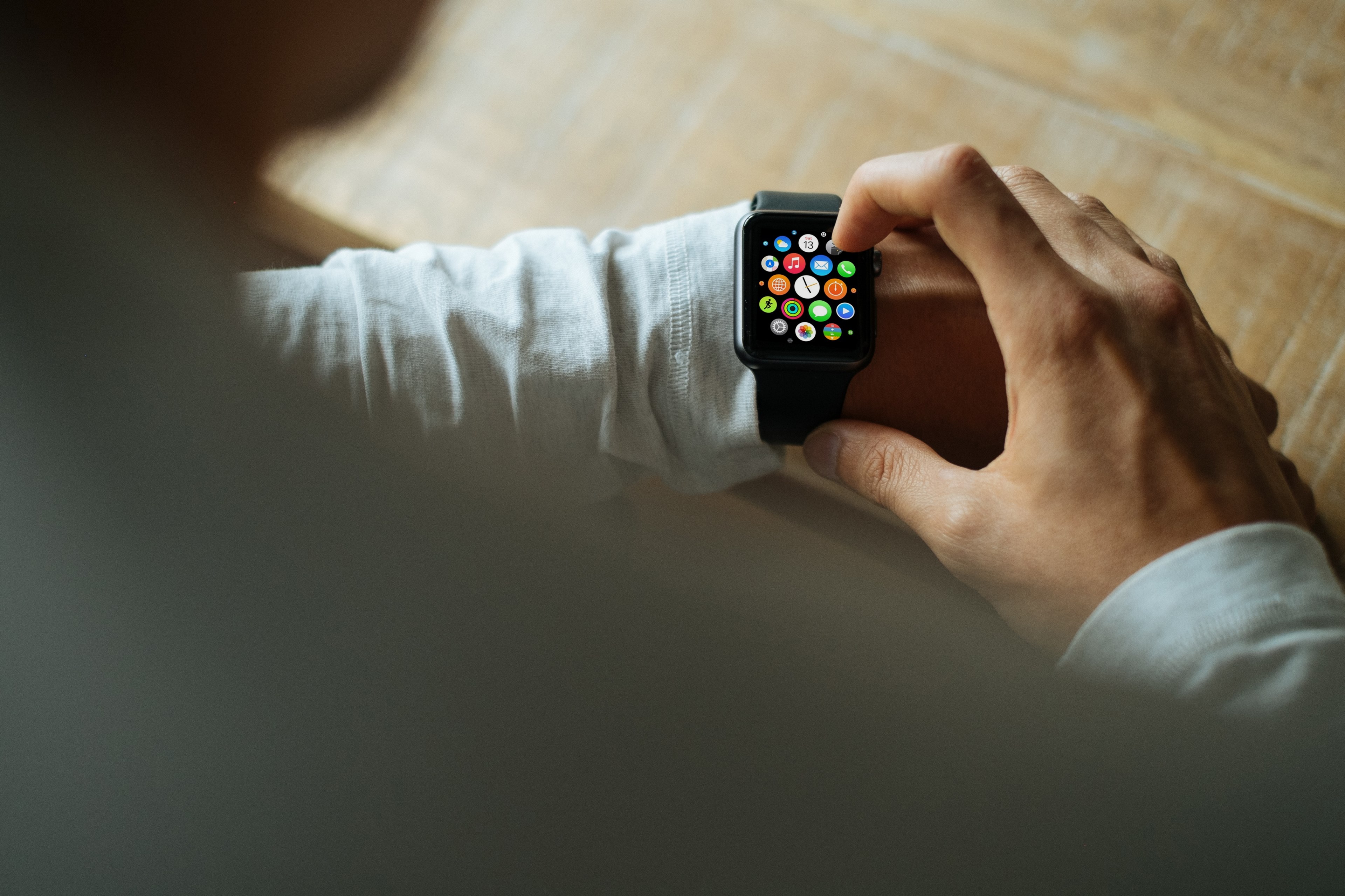 a man in a white sweater wearing and using an apple watch with a black band, man using black apple watch 4k, HD Wallpaper