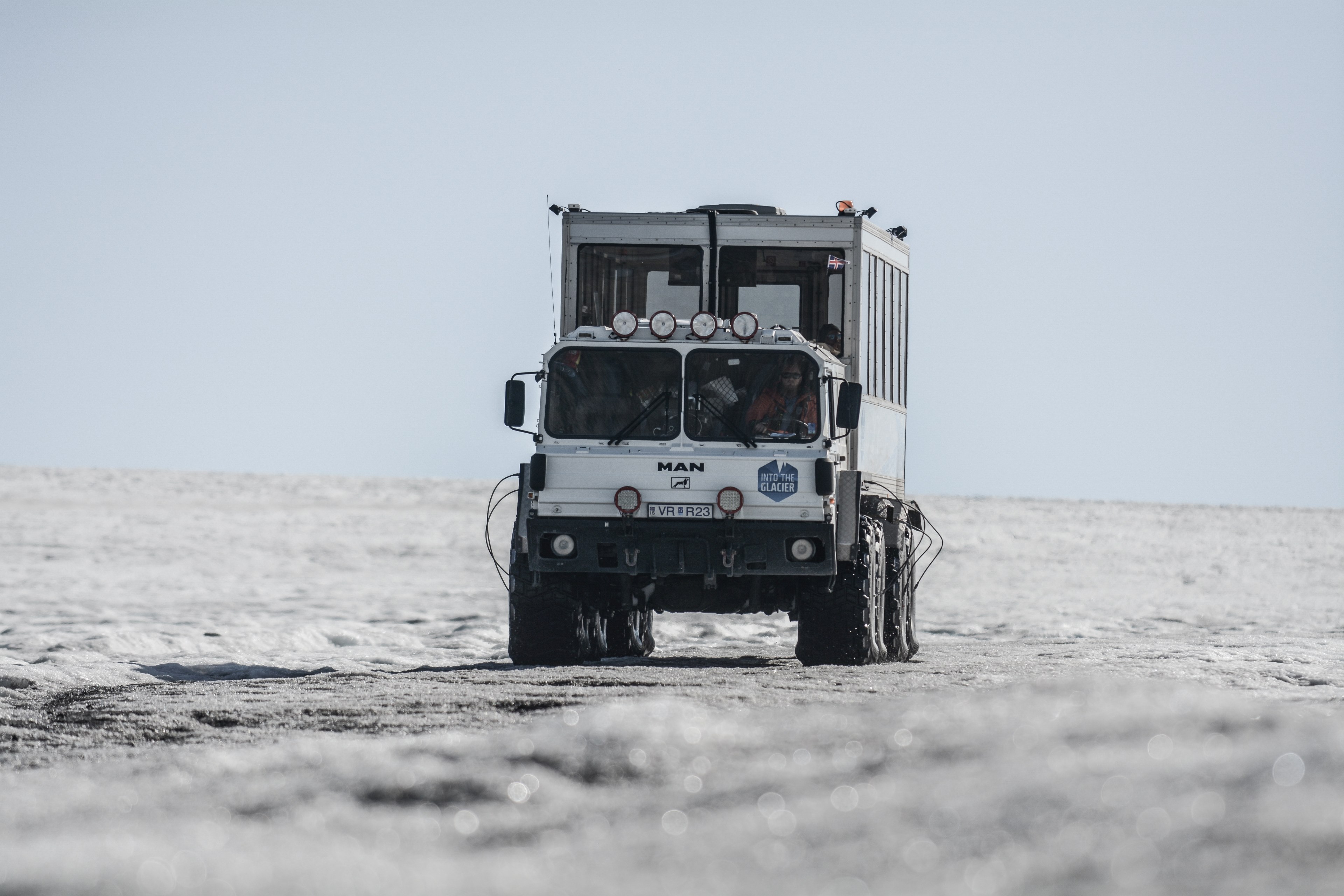 a white truck with a metal cube container with windows in it driving down a barren white wasteland, truck in a wasteland 4k, HD Wallpaper