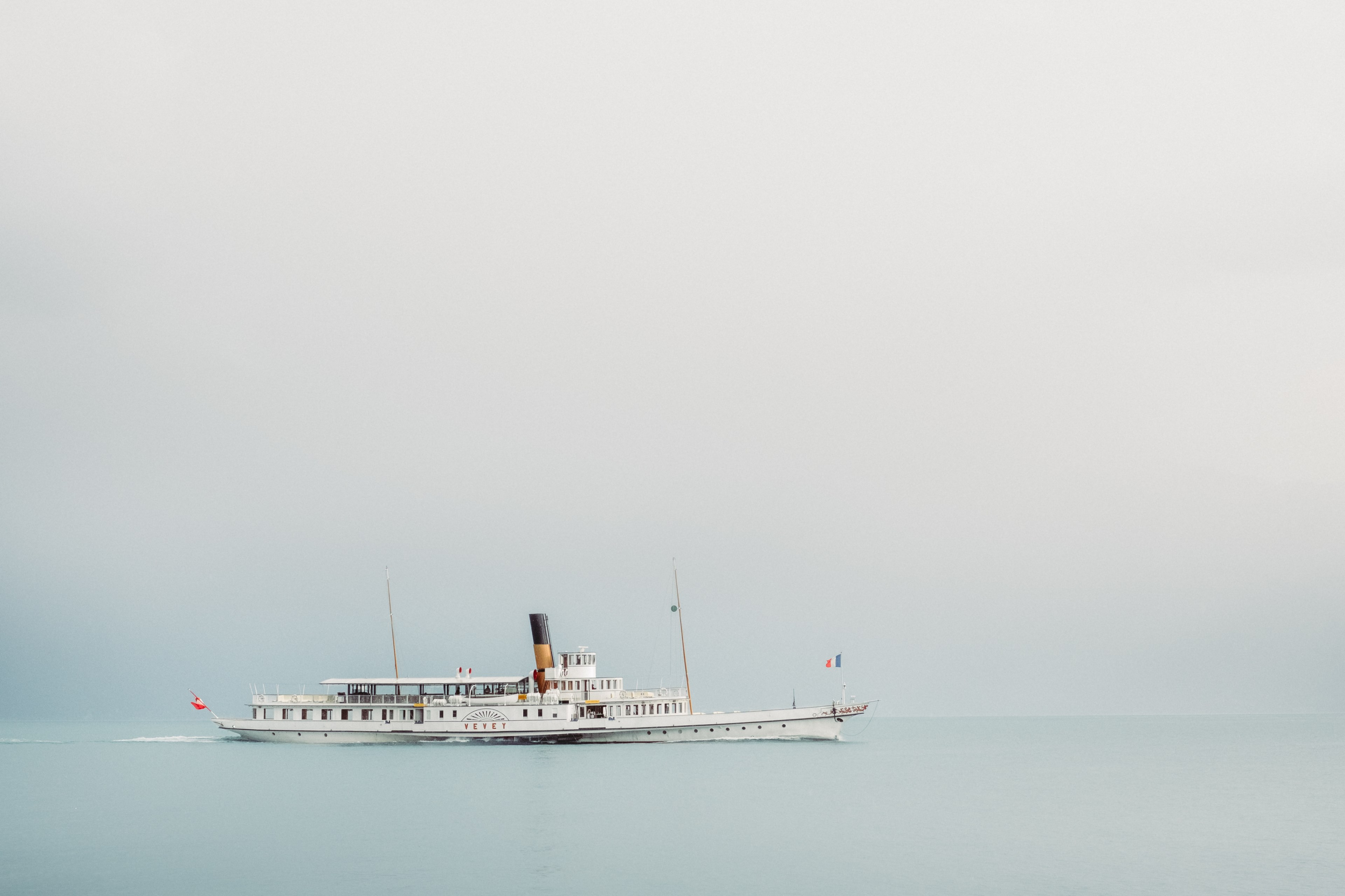 a beautiful steamboat gliding over the calm ocean in vevey on a foggy day, ocean vessels in vevey 4k, HD Wallpaper