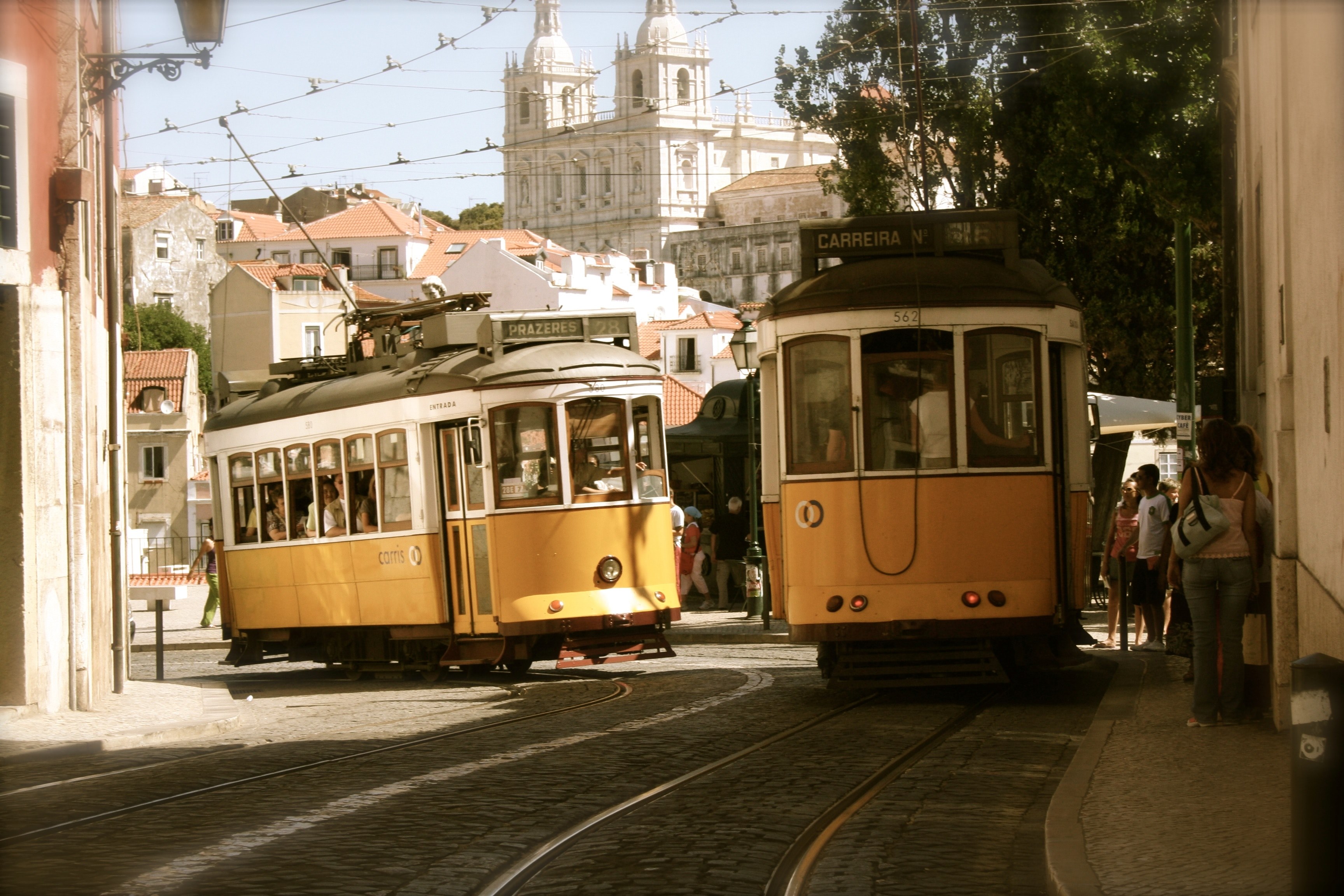 trolley cars on rails on a side street in a sunlit portuguese city, trolley cars in a sunny city 4k, HD Wallpaper
