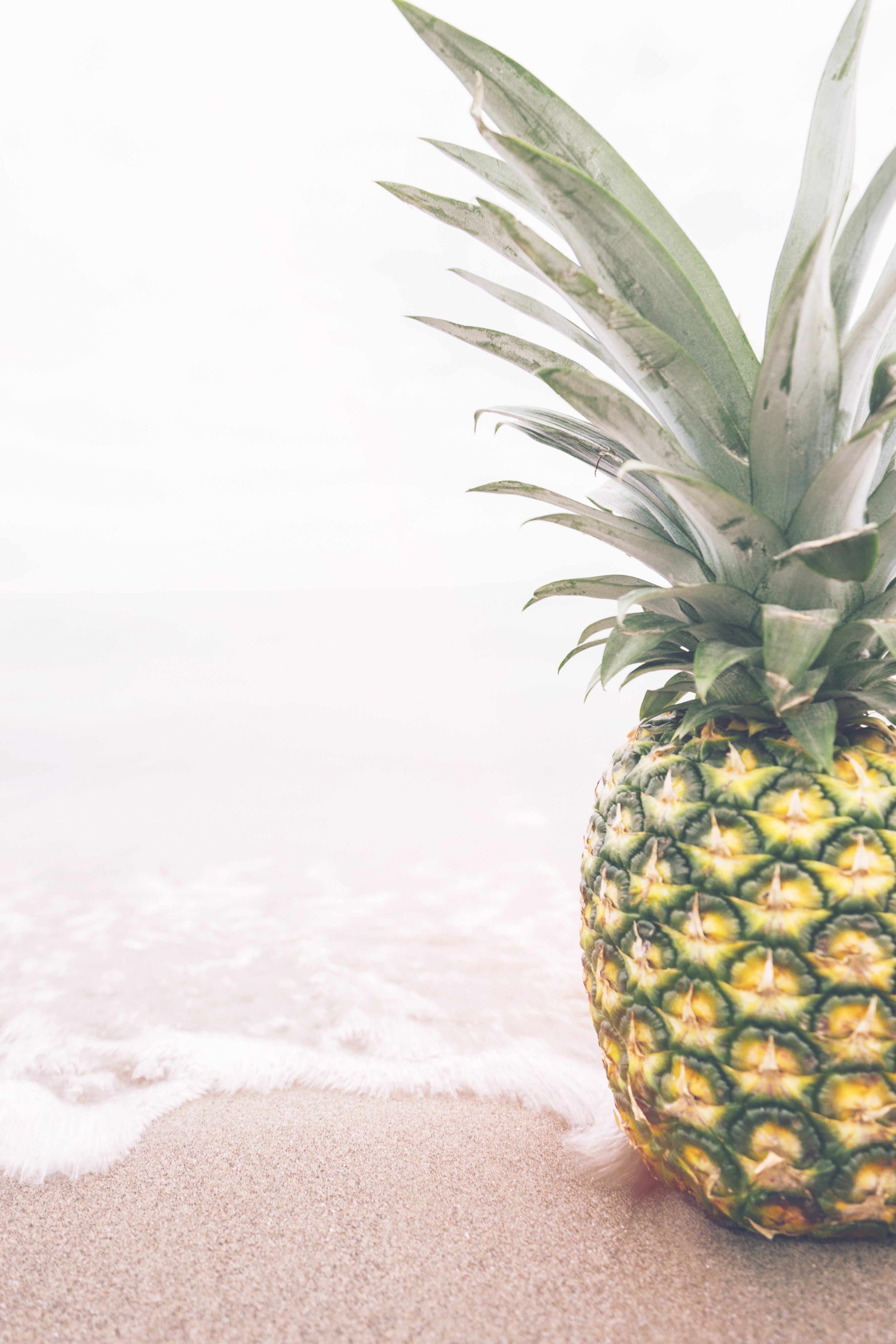 single fresh pineapple sitting on the ocean shoreline, pineapple on the beach 4k, Phone HD Wallpaper