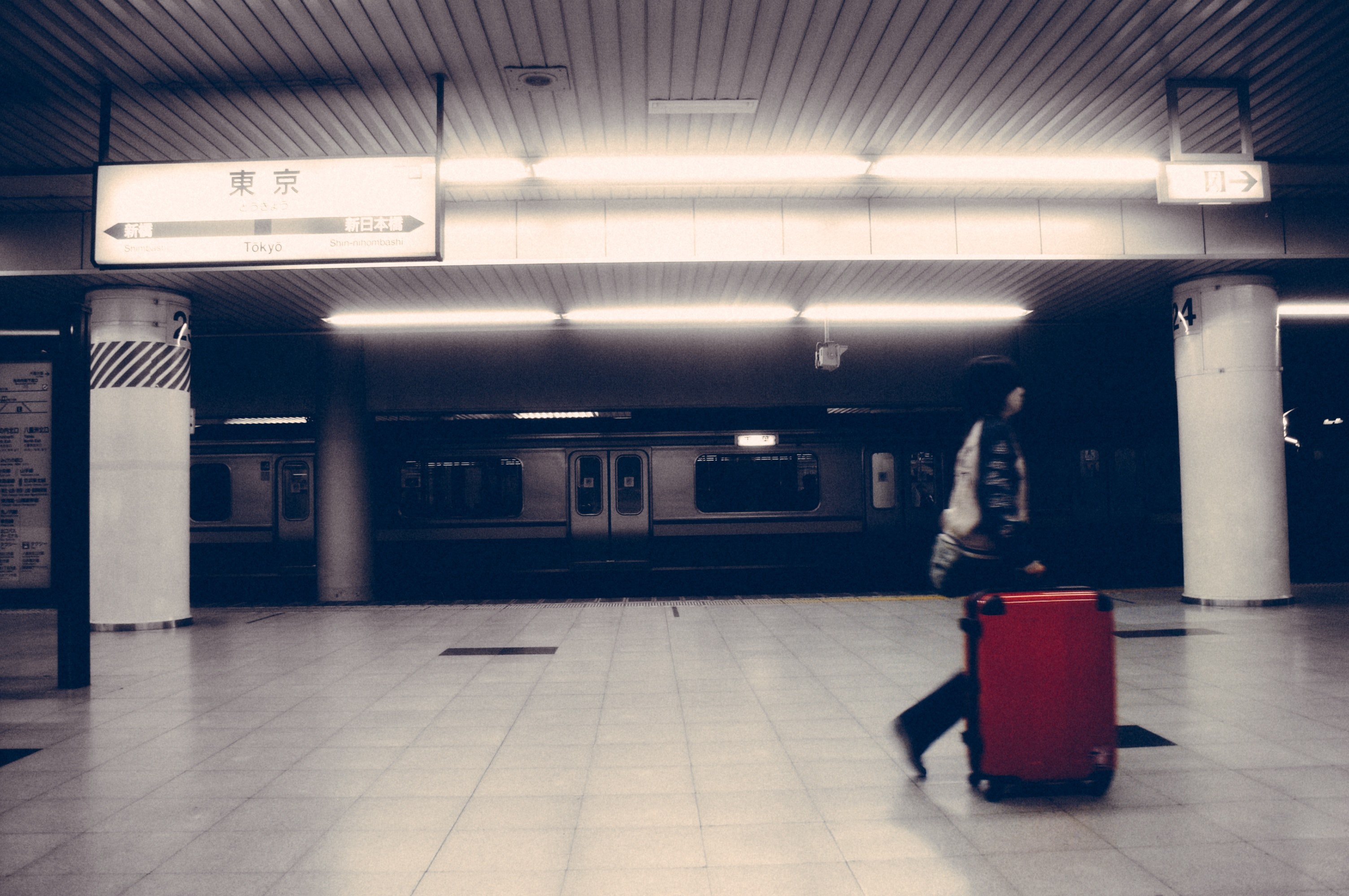 person with red suitcase walks past a subway car in an underground station, suitcase in train station 4k, HD Wallpaper