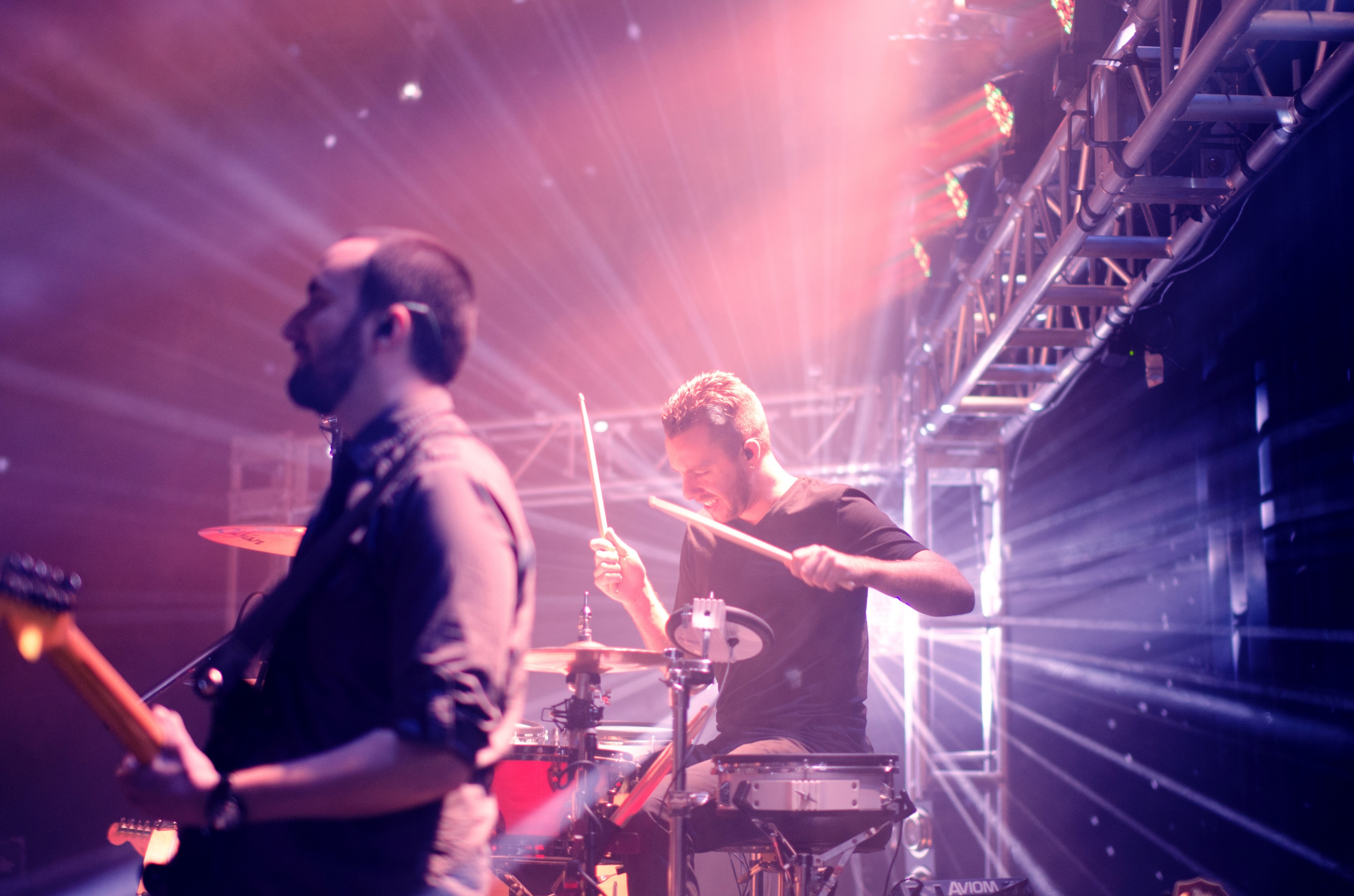 a guitarist and a drummer performing in bright rays of light, rock concert in intense light 4k, HD Wallpaper