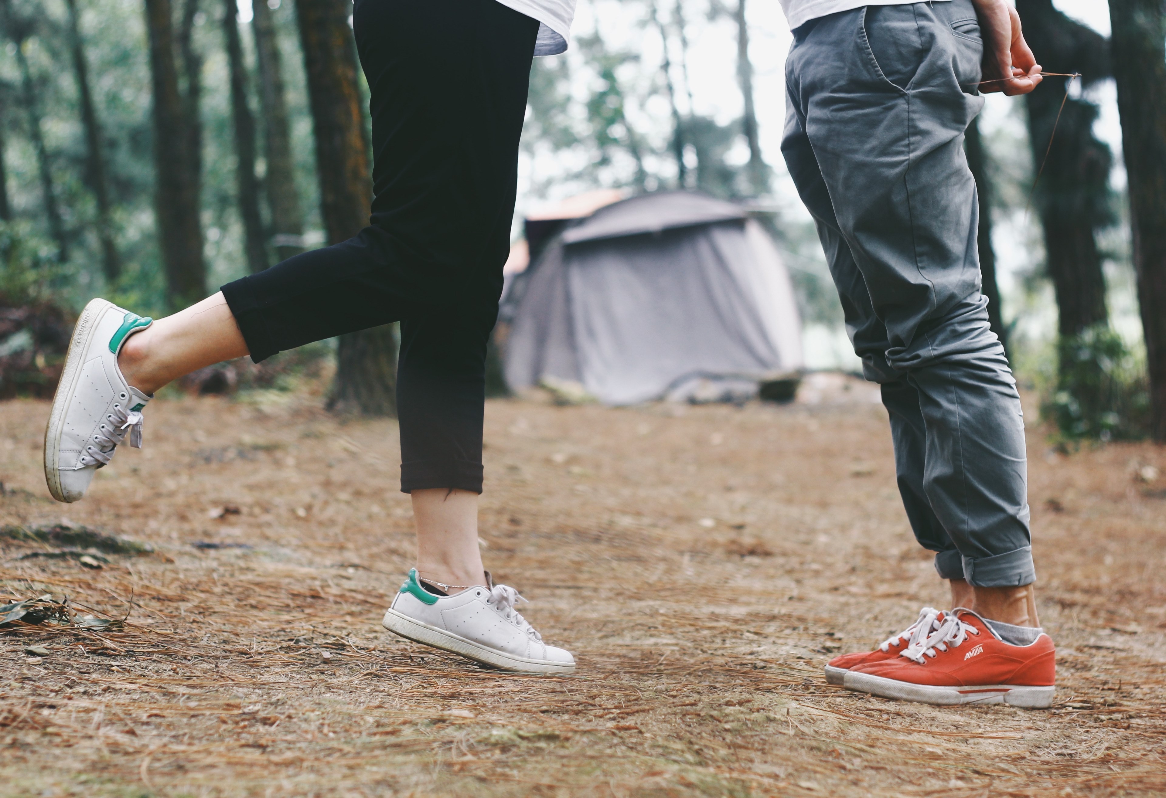two peoples legs standing on dirt at a campsite in hanoi in front of a tent, love is 4k, HD Wallpaper