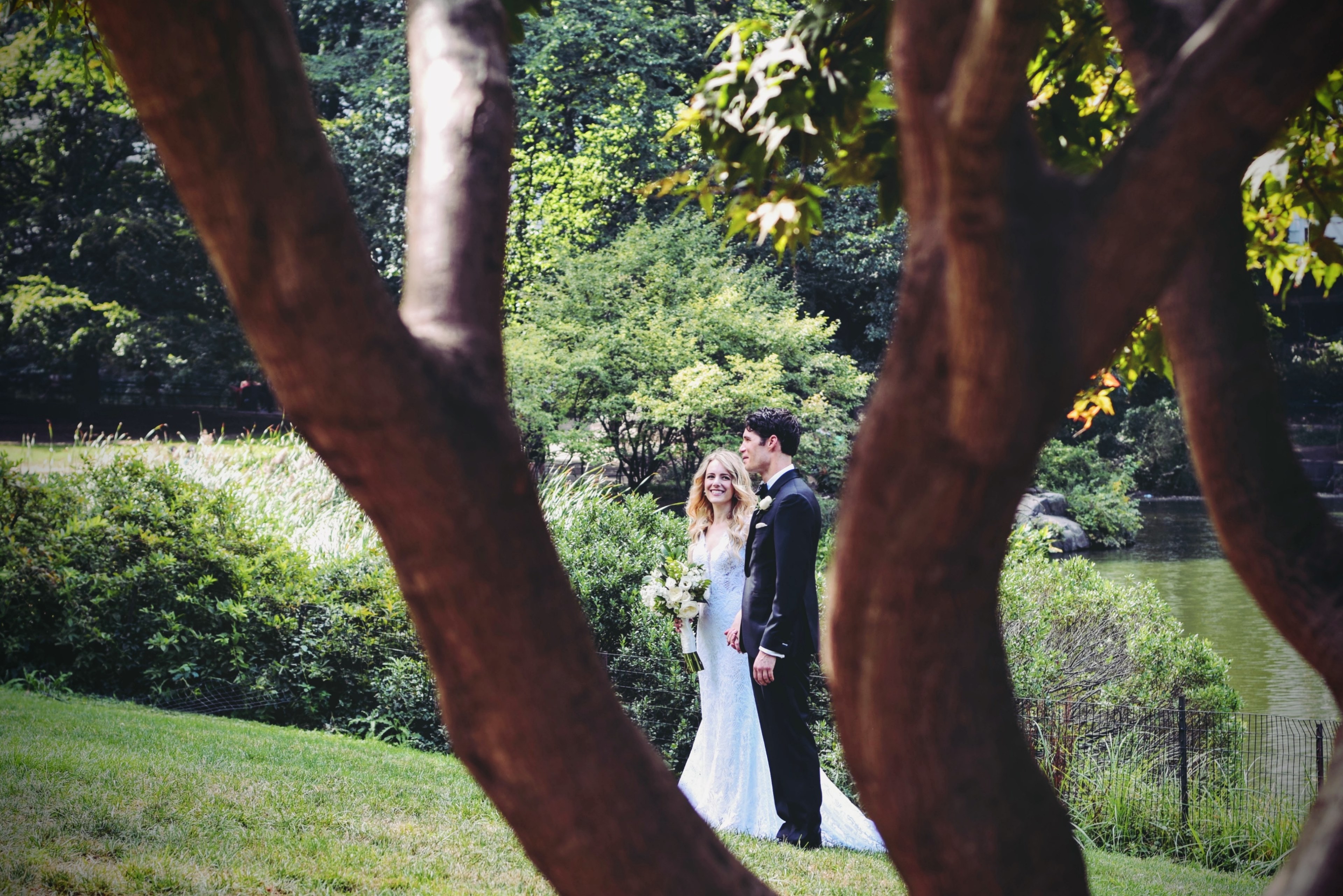 wedding couple stands in central park south holding hands in front of a pond, newlyweds at central park south 4k, HD Wallpaper
