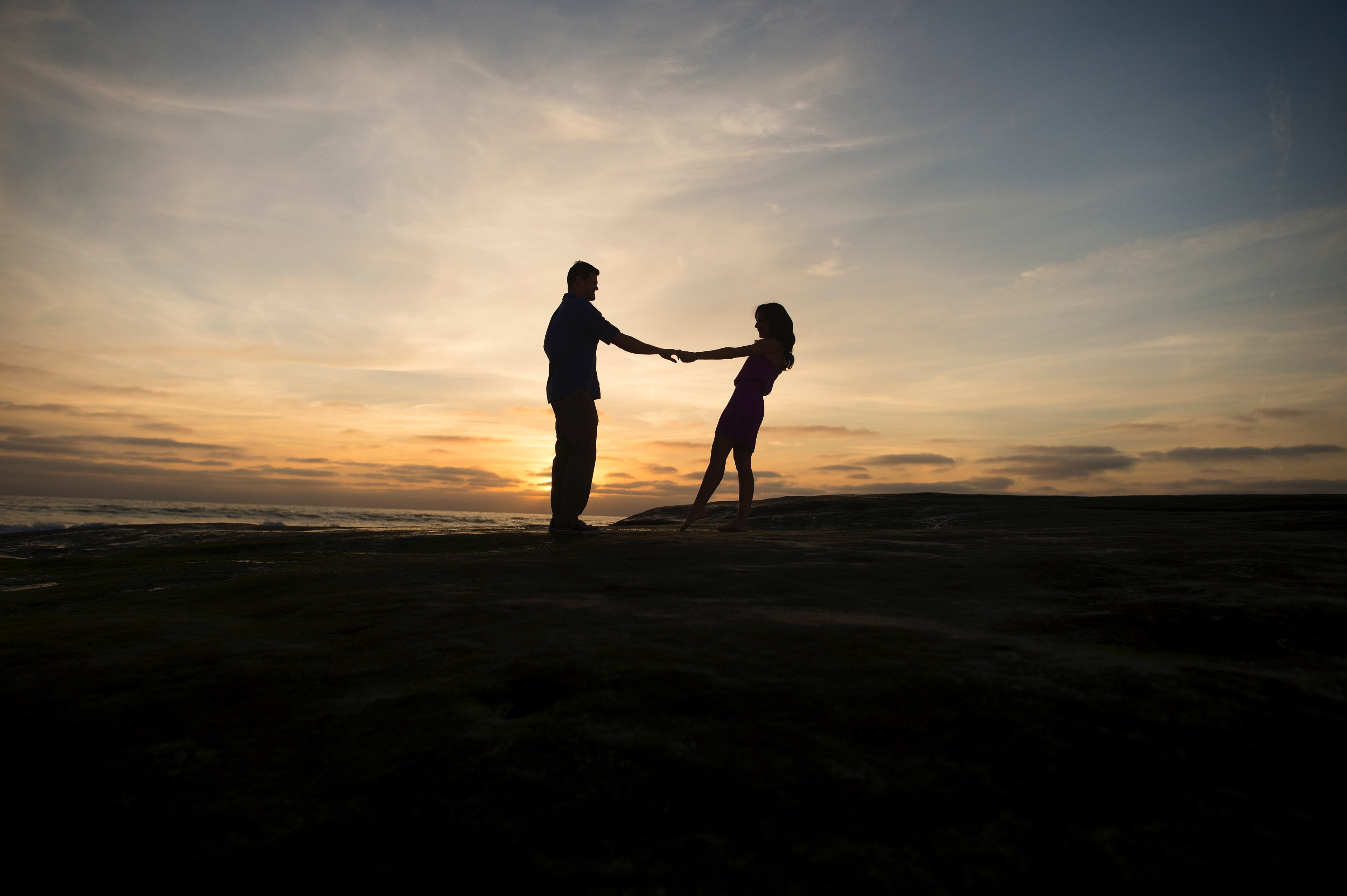 couple spins round holding hands silhouetted against setting the sun, spin me round 4k, HD Wallpaper