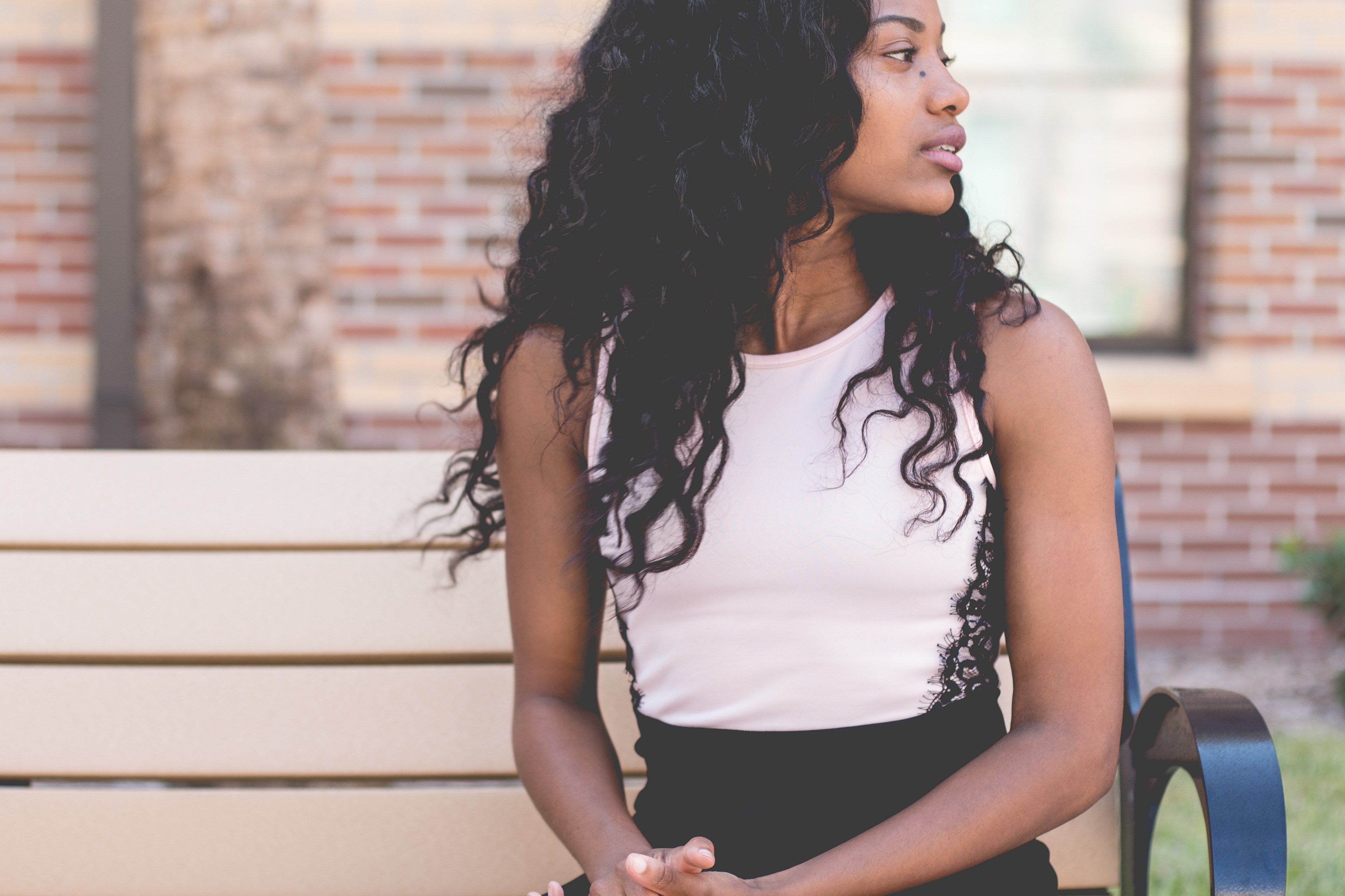 woman with black hair sitting on steps in front of red brick building in daytona beach, woman on steps 4k, HD Wallpaper