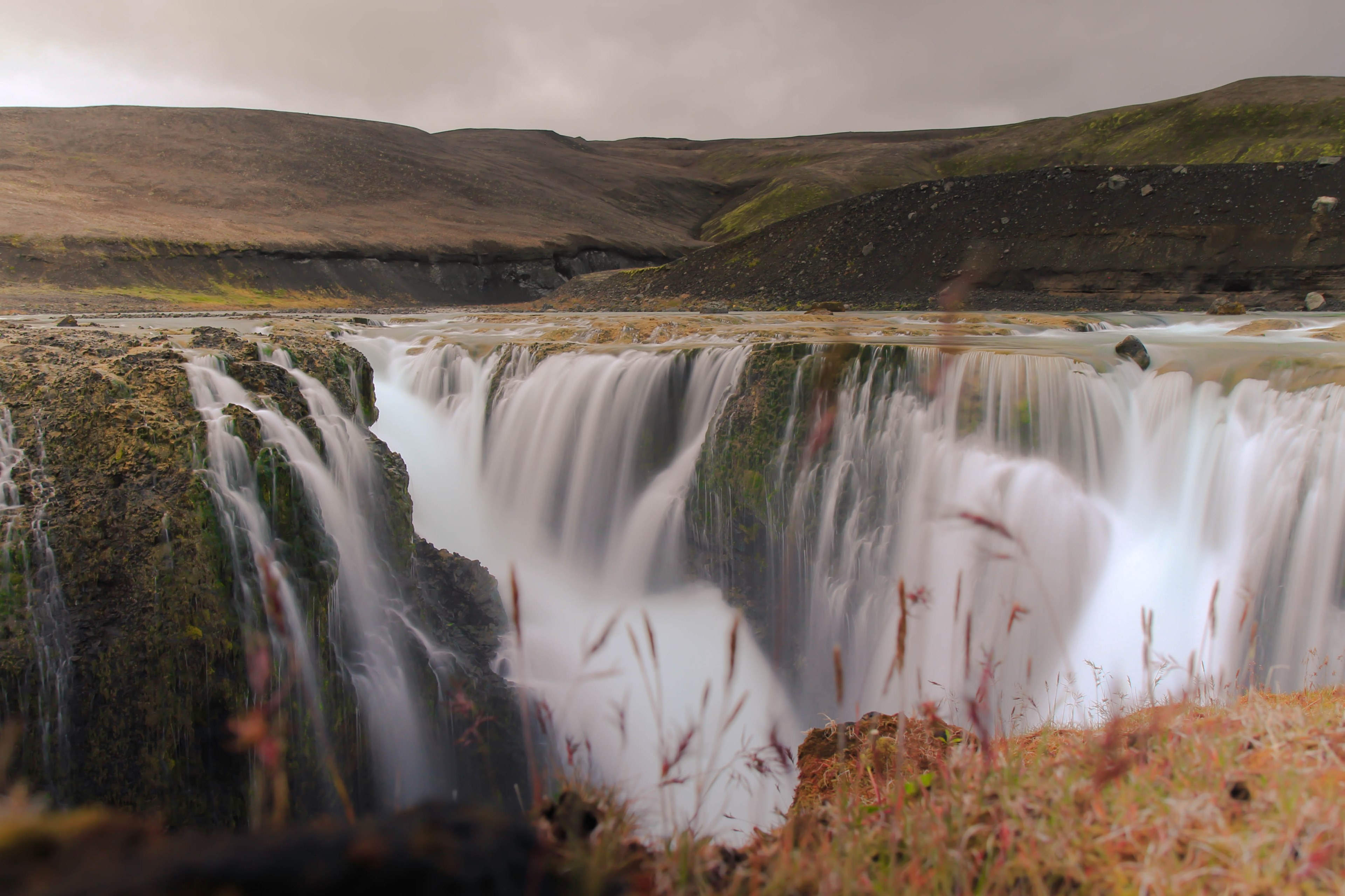 a scenic autumn shot of large waterfalls with rocky mountains in the background, autumn waterfalls near mountains 4k, HD Wallpaper