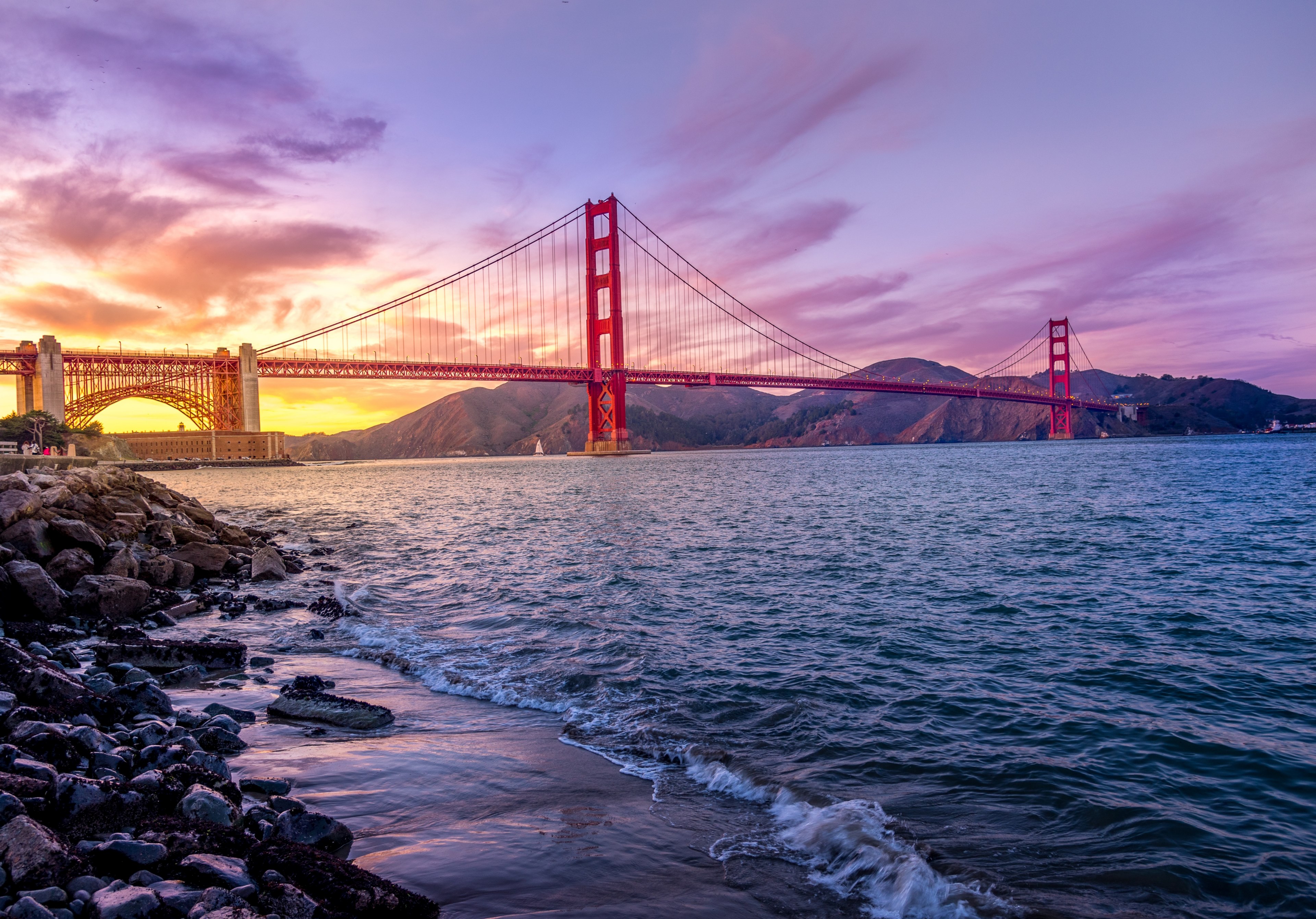 a purple and yellow sunset behind golden gate bridge in san fransisco with waves breaking on the shoreline, golden gate purple sunset_ 4k, HD Wallpaper