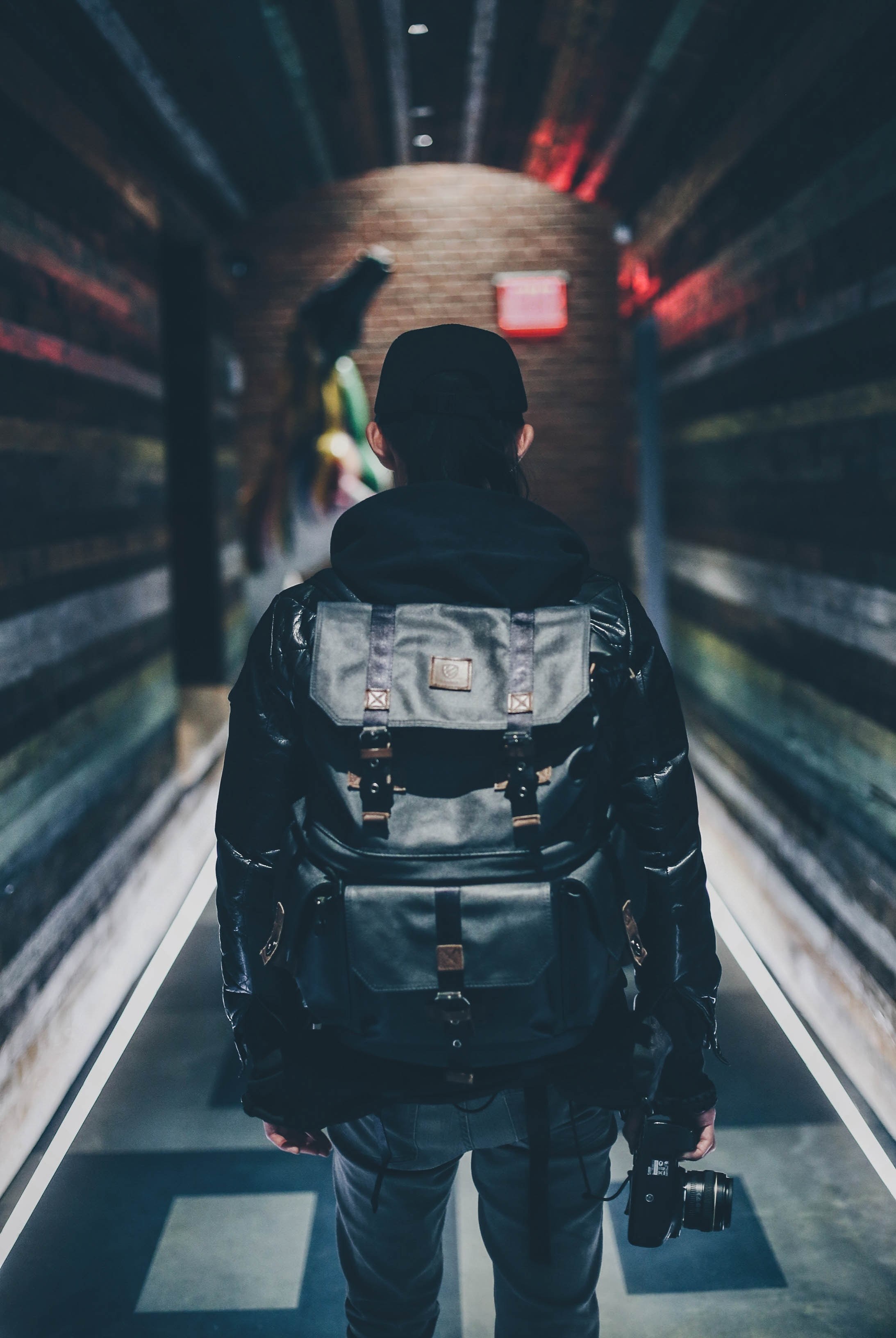 person in a backpack walks down a dark urban tunnel, langly alanking dizzy_d718 4k, Phone HD Wallpaper