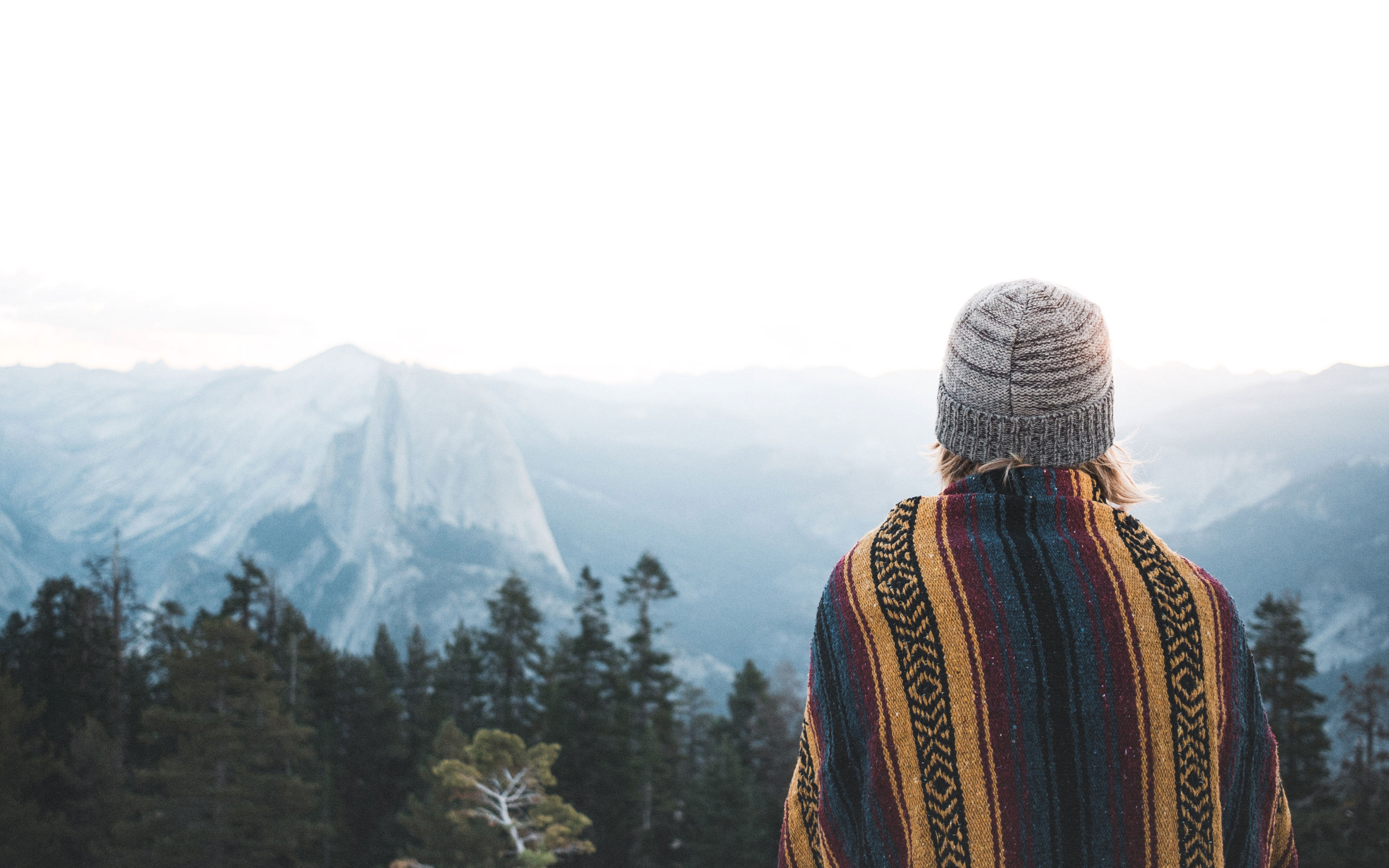 a woman in a knit cap looking off on the distant cliffs in yosemite valley, distant yosemite cliffs 4k, HD Wallpaper