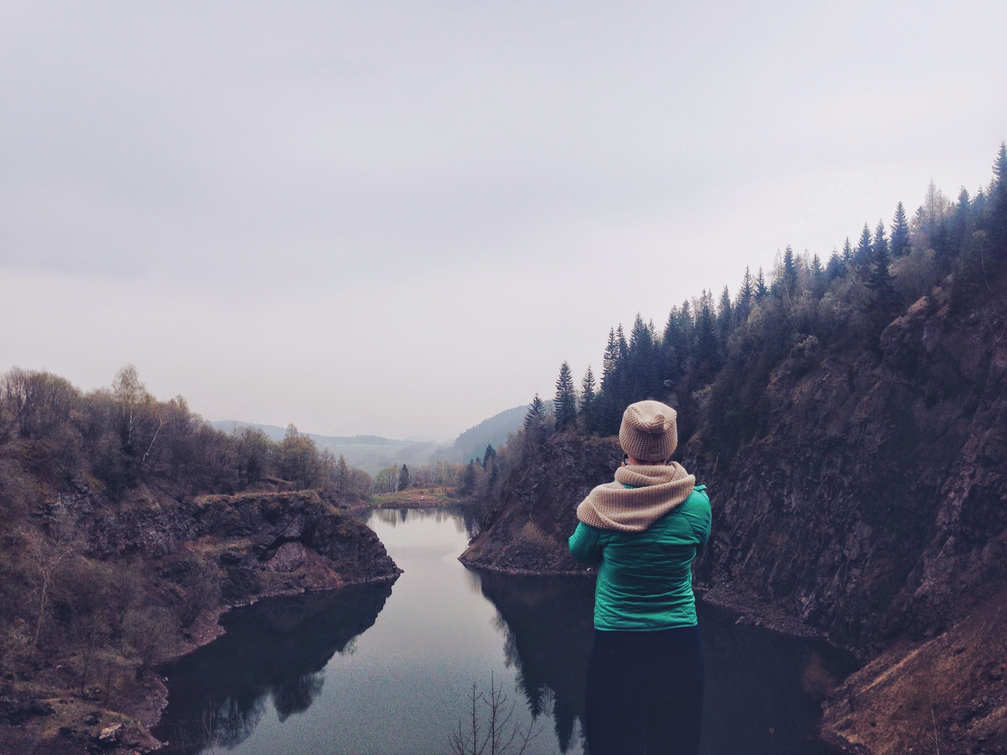 a woman admiring a small lake in a rocky basin on a cloudy day, woman looking off into a rocky basin 4k, HD Wallpaper
