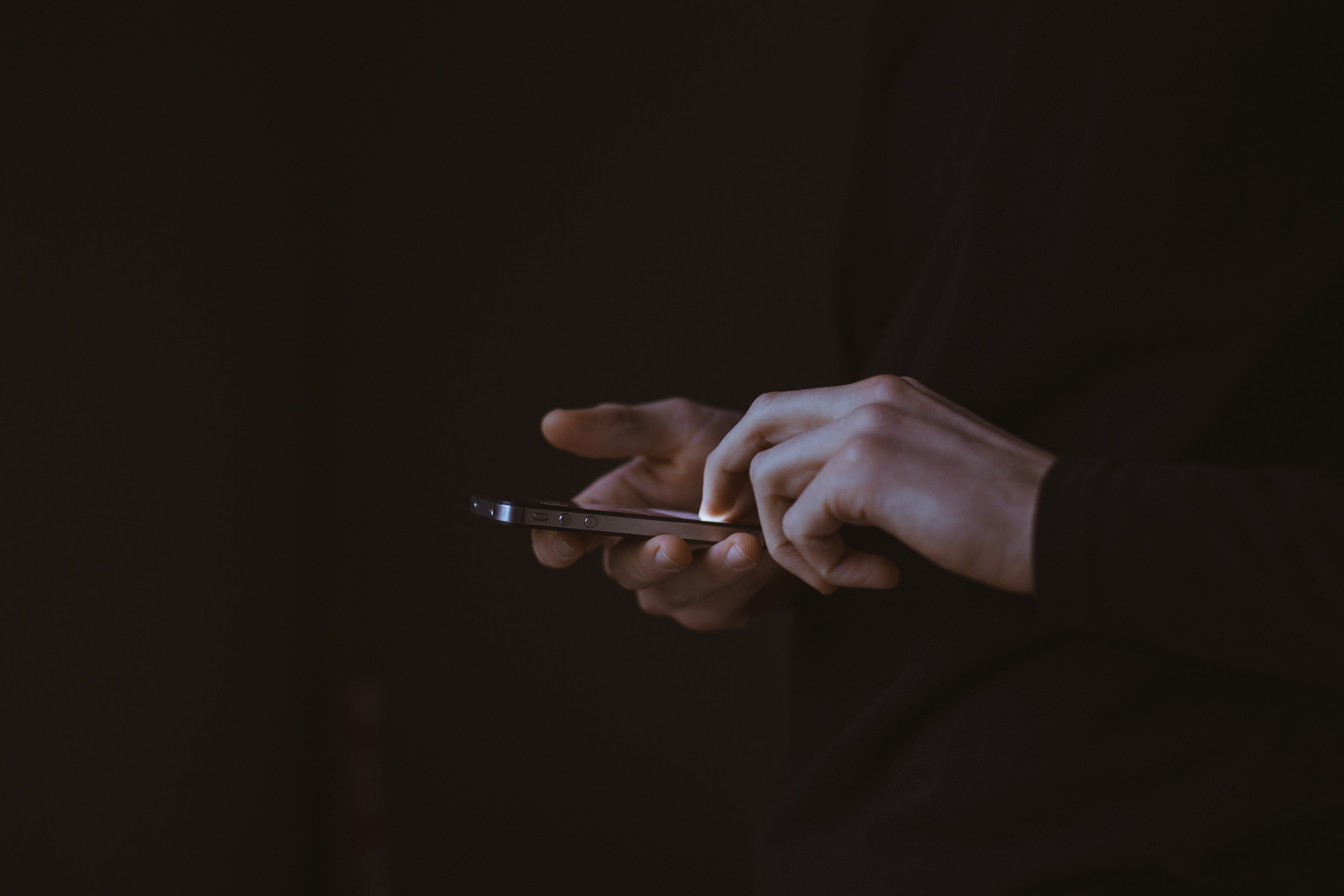 a man in black suits hand operating an apple company gadget an iphone smartphone, man on a smartphone 4k, HD Wallpaper