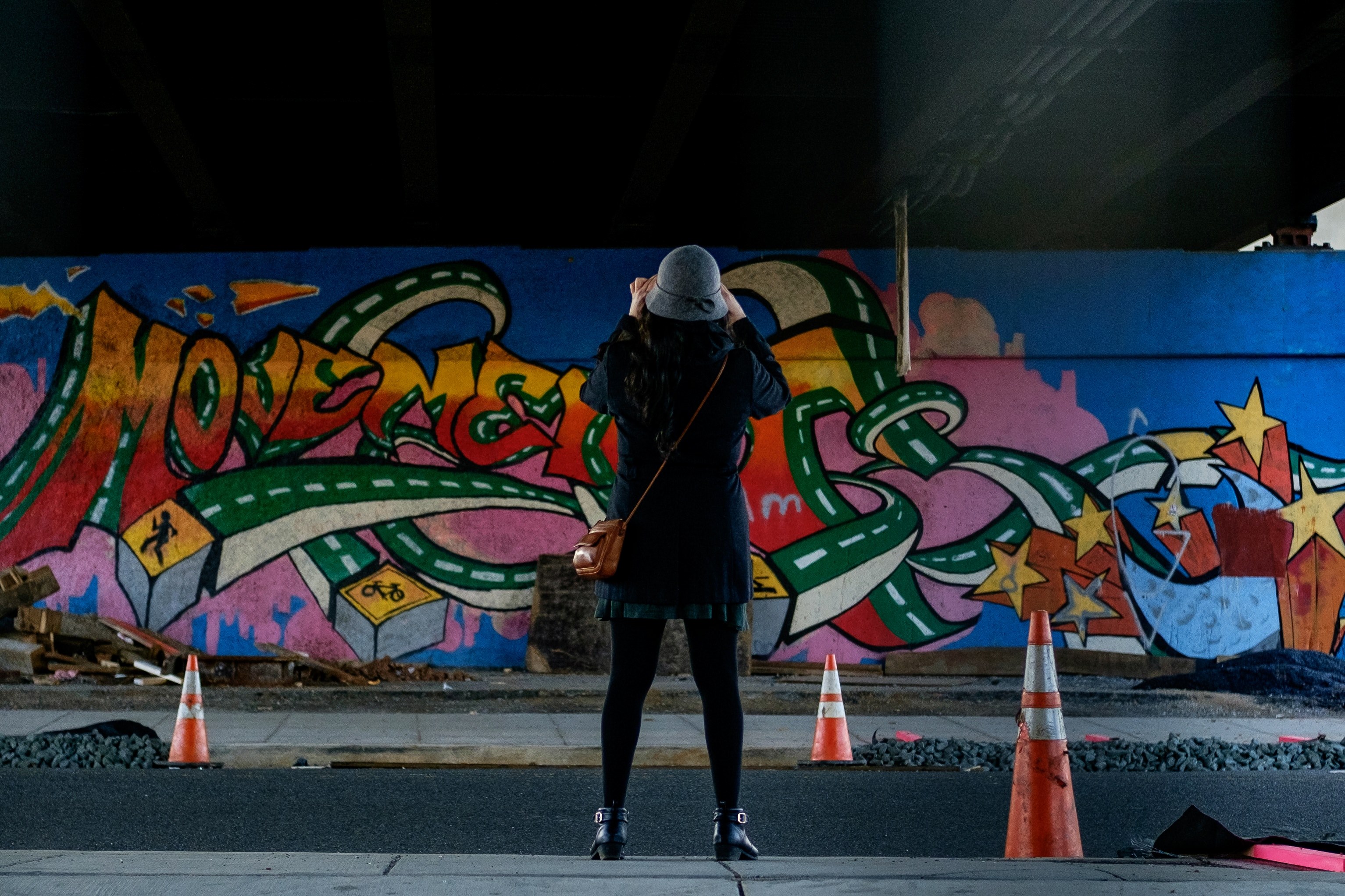 woman in felt hat with traffic cones viewing colorful graffiti street art rhode island avenue northwest, woman in front of graffiti underpass 4k, HD Wallpaper