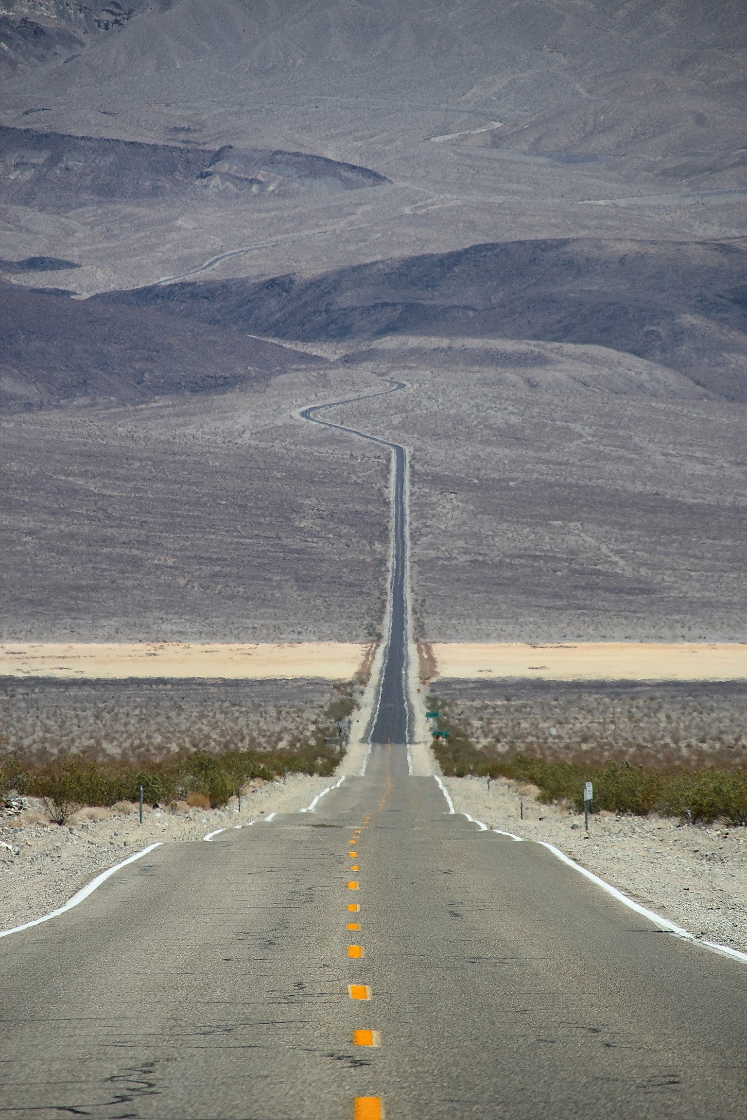 empty rural highway road creates a line through the desert terrain, driving through desert terrain 4k, Phone HD Wallpaper