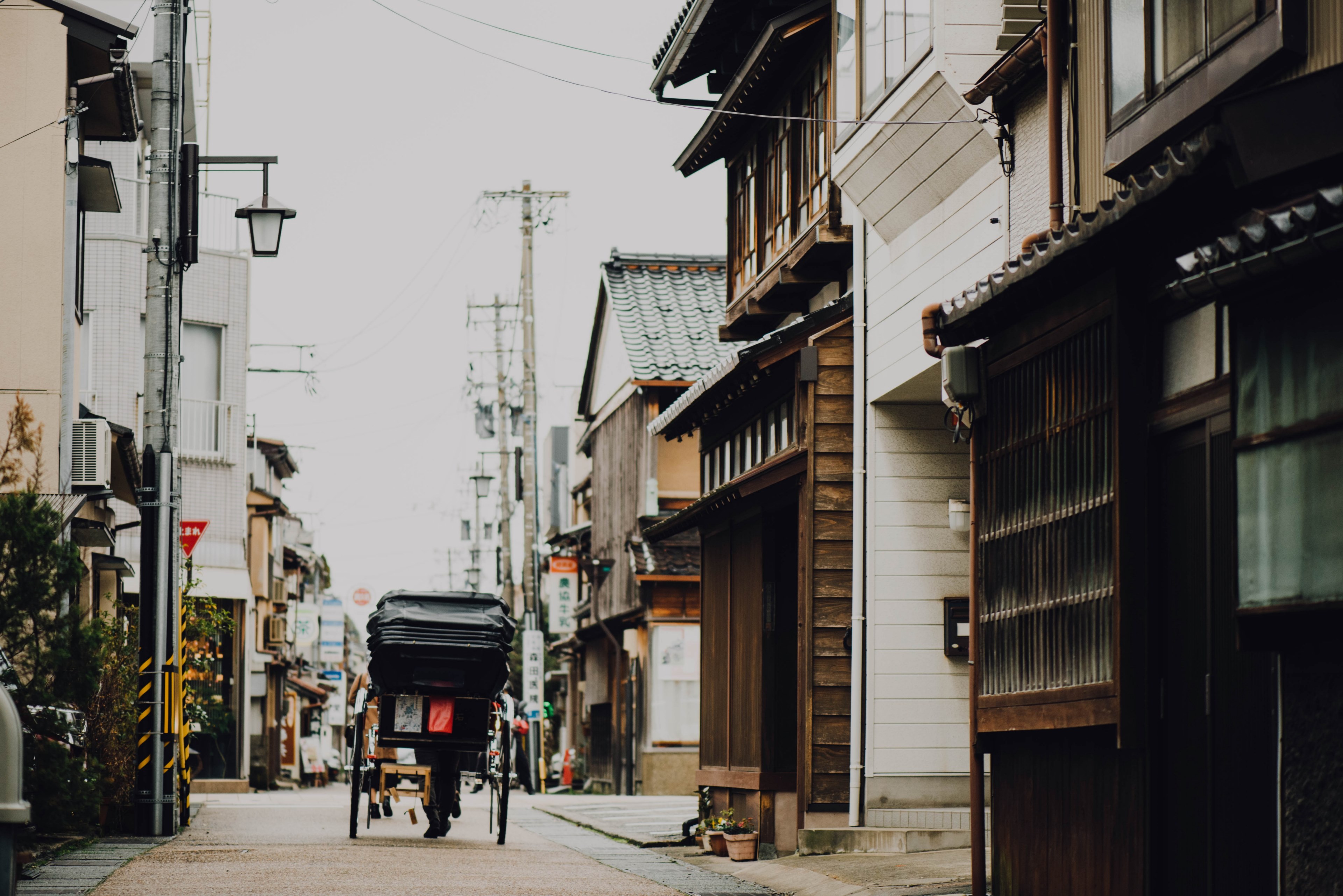 asian street with a carriage going down the road lined with buildings and power lines, asian street and carriage 4k, HD Wallpaper