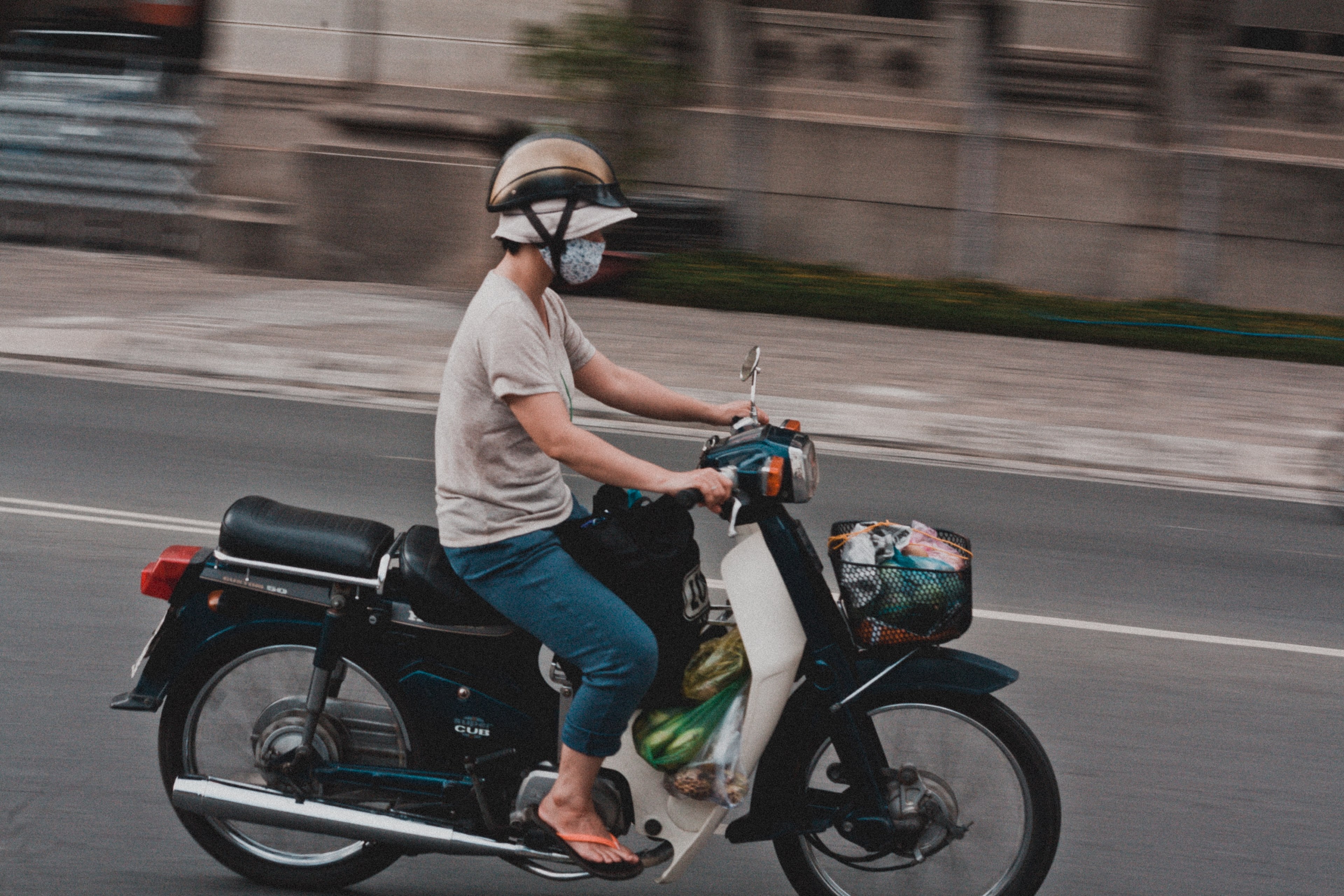 man riding a motorcycle with grocery plastic bags while wearing a mouth mask and a hat, speed 4k, HD Wallpaper