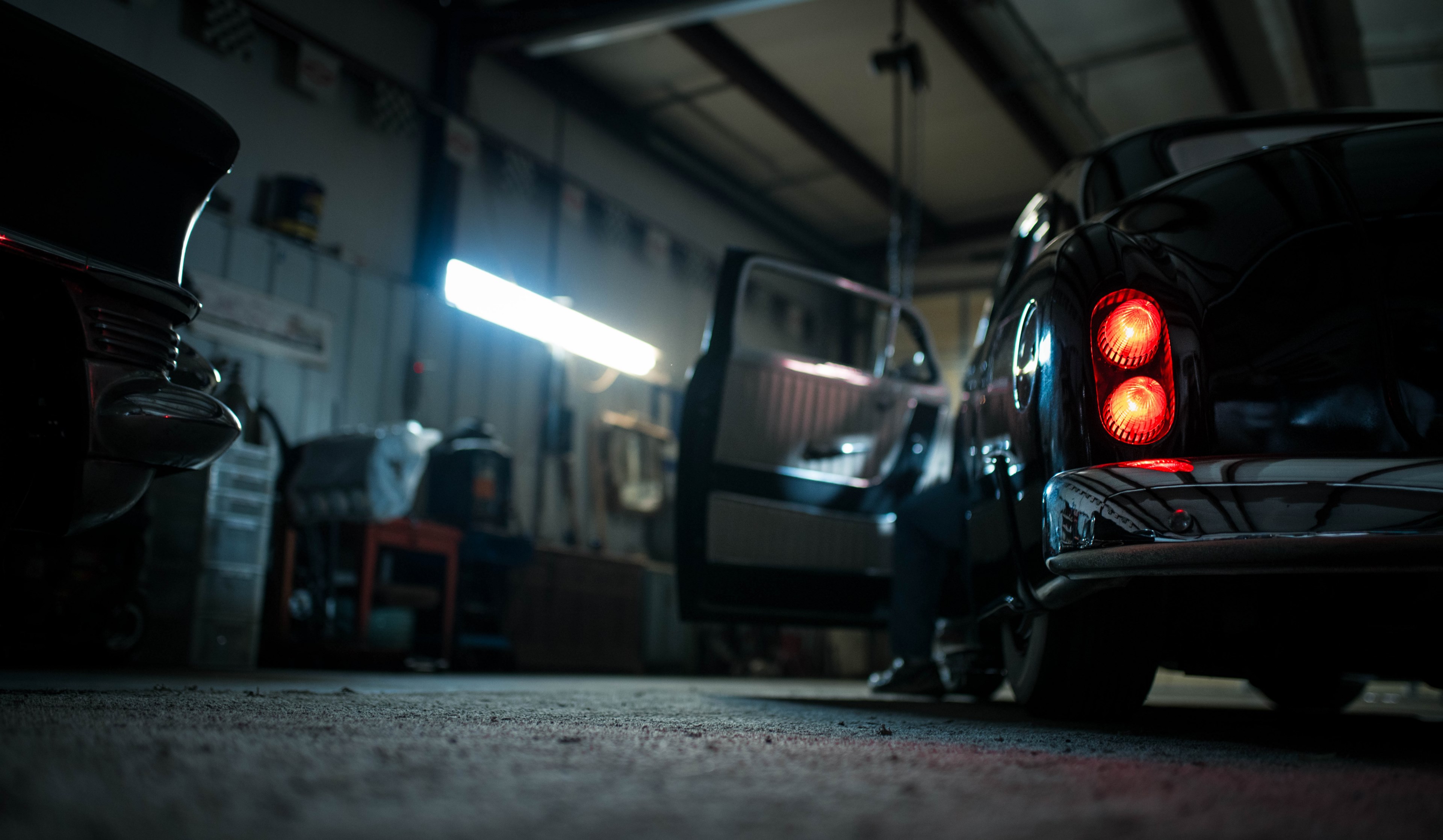 a ground pov shot of a vintage car in a dimly lit garage, _vintage car garage 4k, HD Wallpaper
