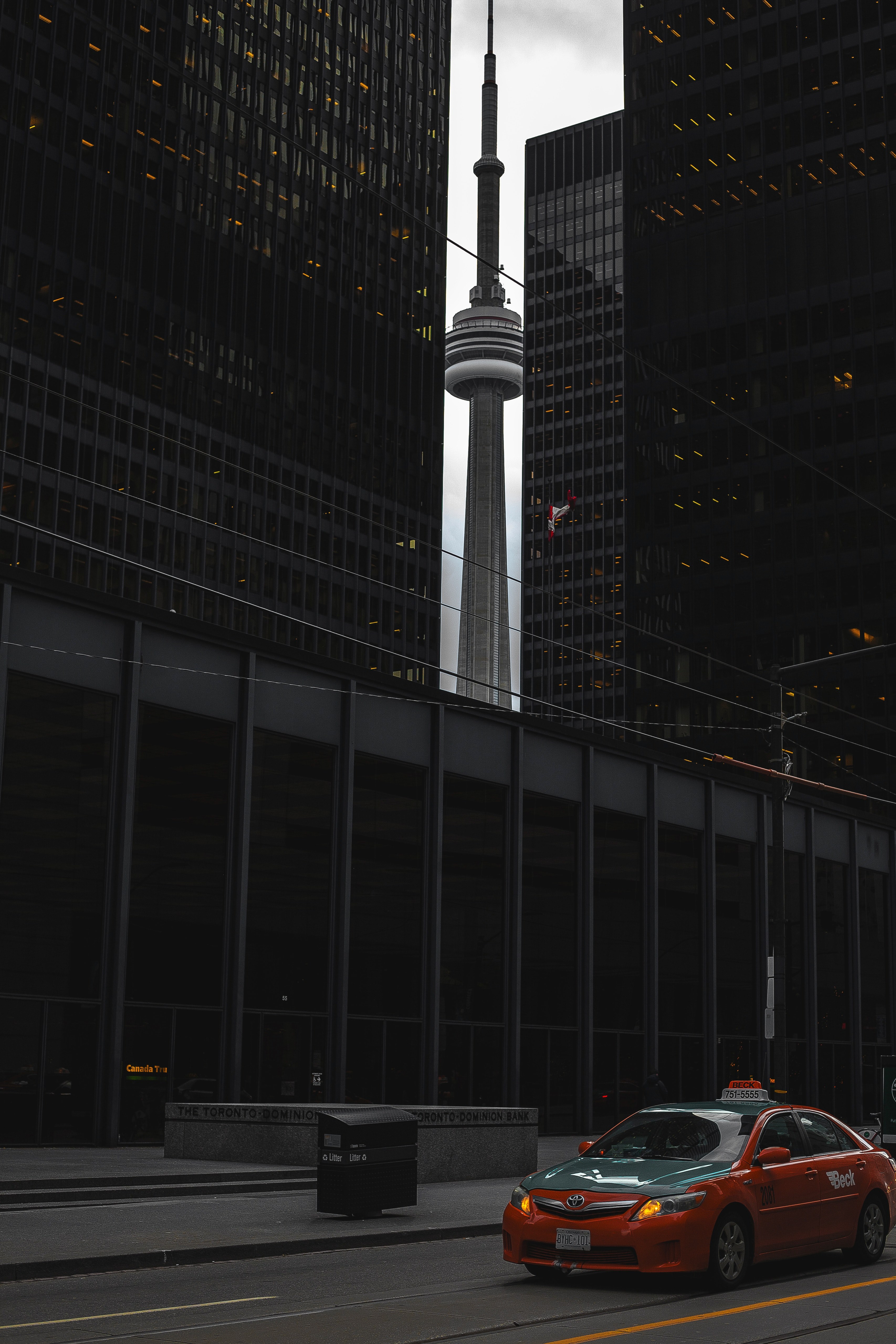 red cab whizzes by a crack between buildings framing a famous landmark, between buildings 4k, Phone HD Wallpaper