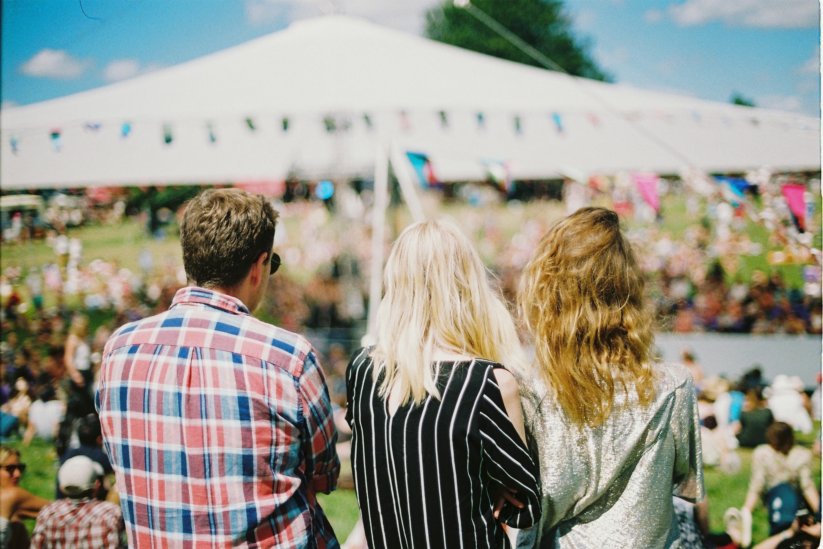 a man and two women standing back to camera at a music festival, young festival goers 4k, HD Wallpaper
