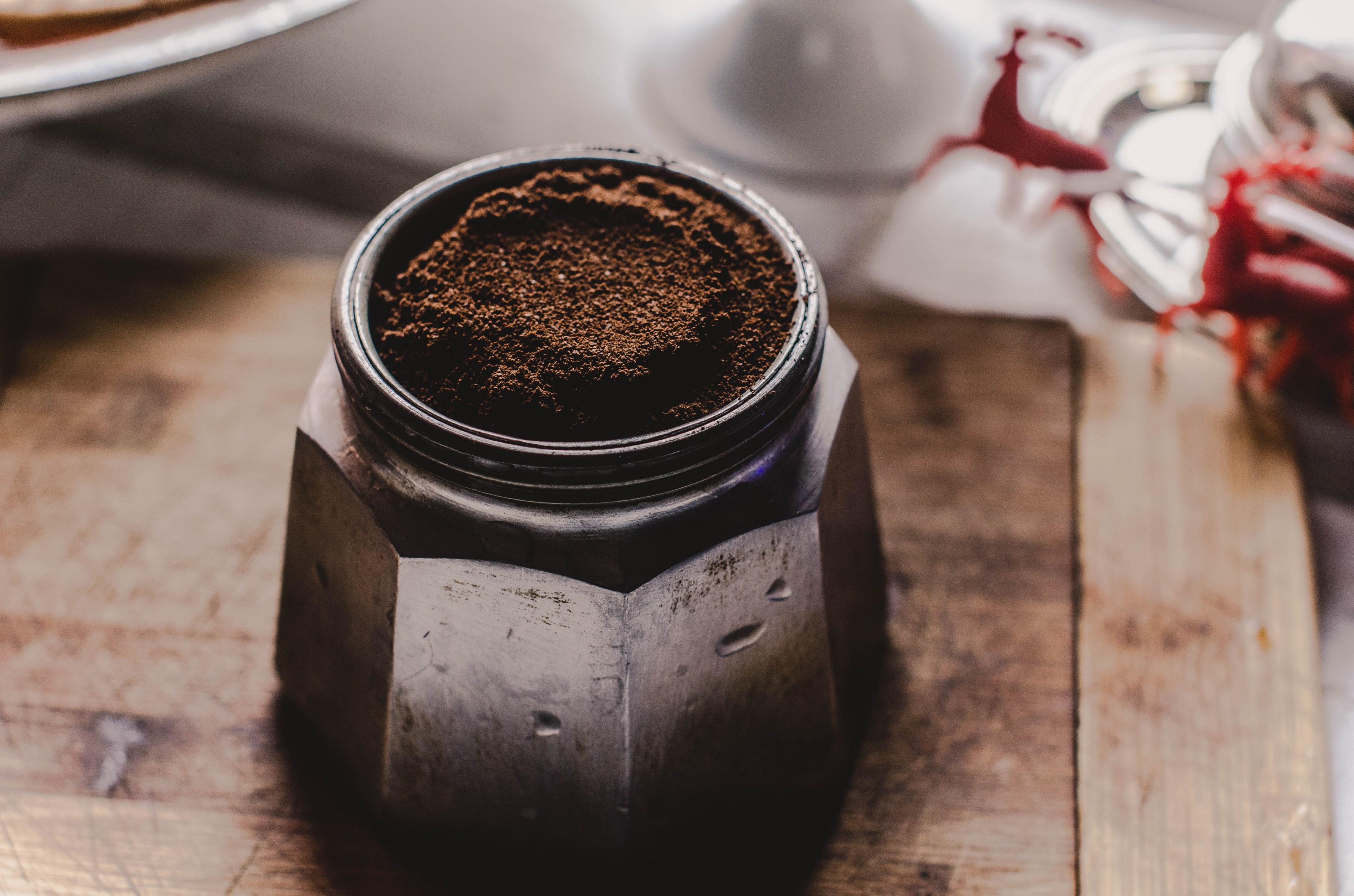 a close up look at coffee grounds in a container sitting on top of a wood board, macro shot of coffee grounds 4k, HD Wallpaper