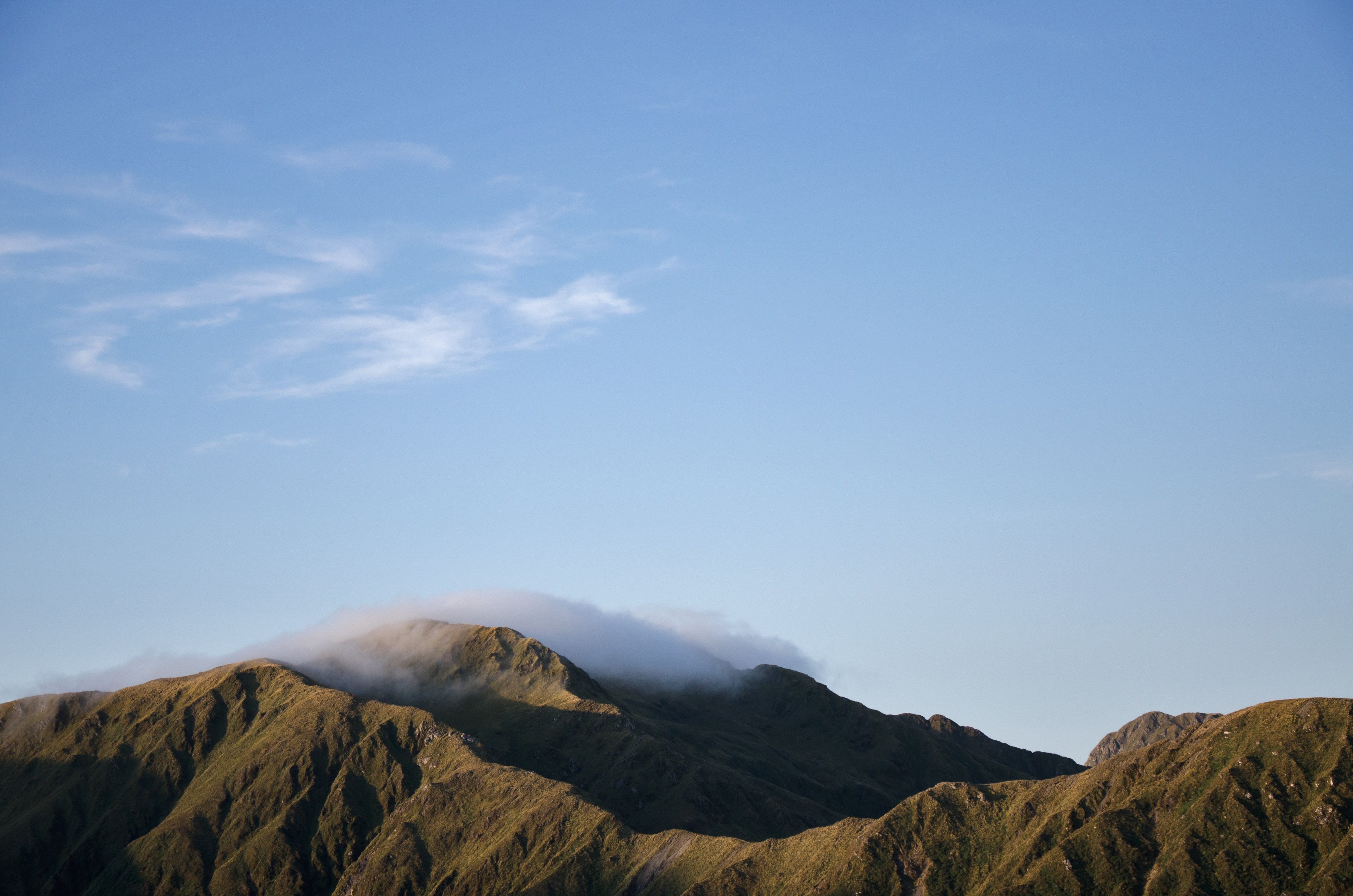 a cloud over the top of a mountain ridge in tararua forest park, cloud capped mountain 4k, HD Wallpaper