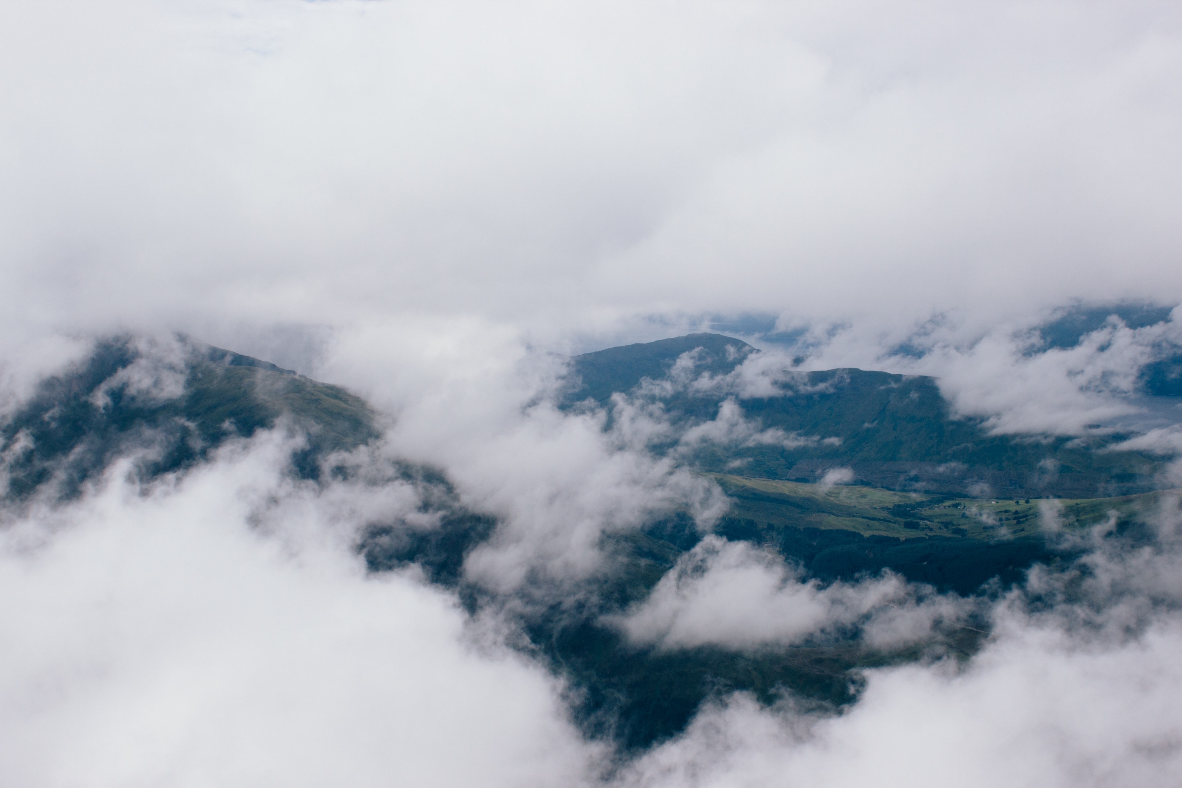 aerial view of the foggy atmosphere over mountains in scotland, scottish highlands under clouds 4k, HD Wallpaper