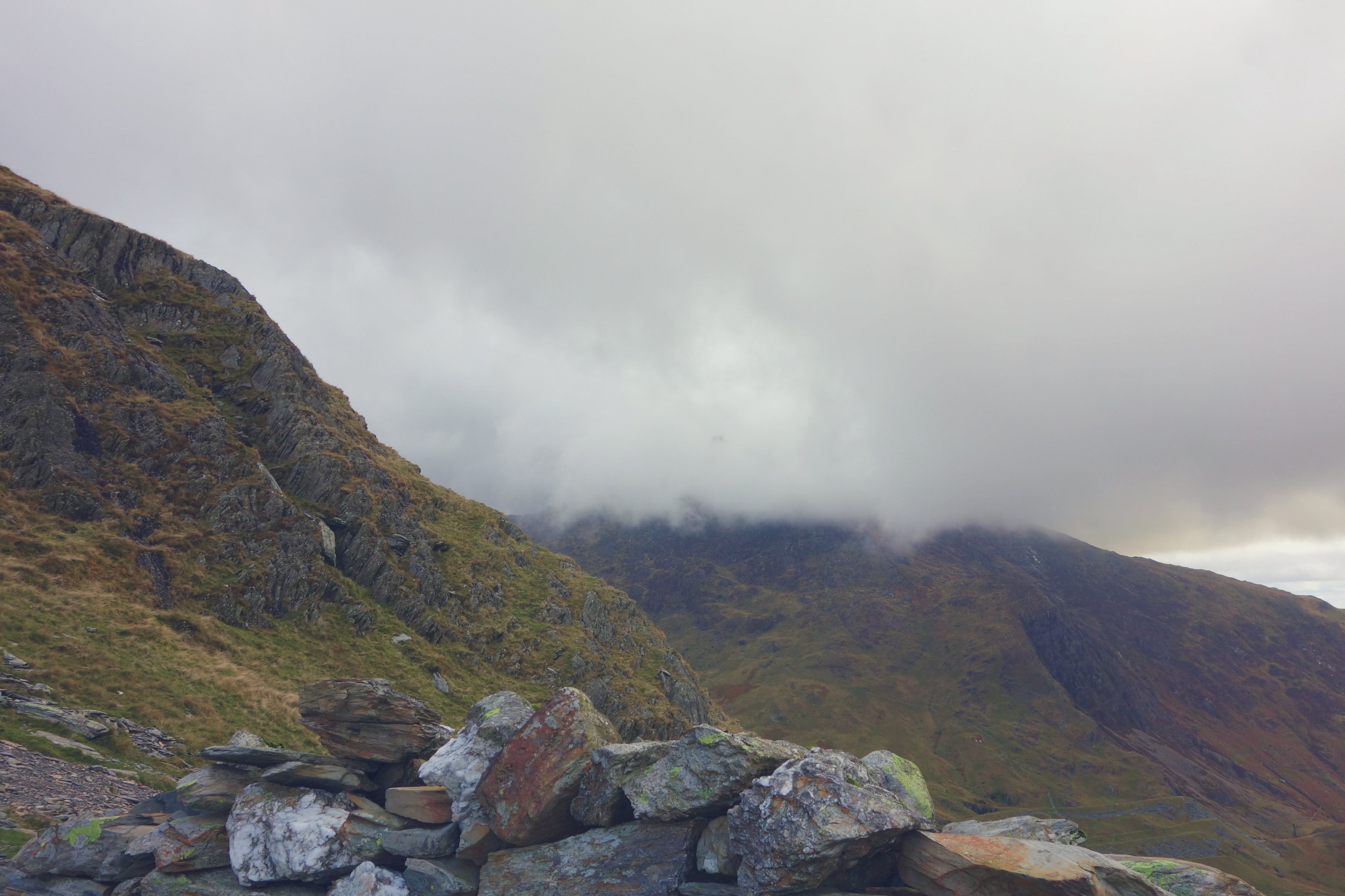 a pile of rocks on a mossy mountain slope near snowdon, clouds over green mountains in scotland 4k, HD Wallpaper