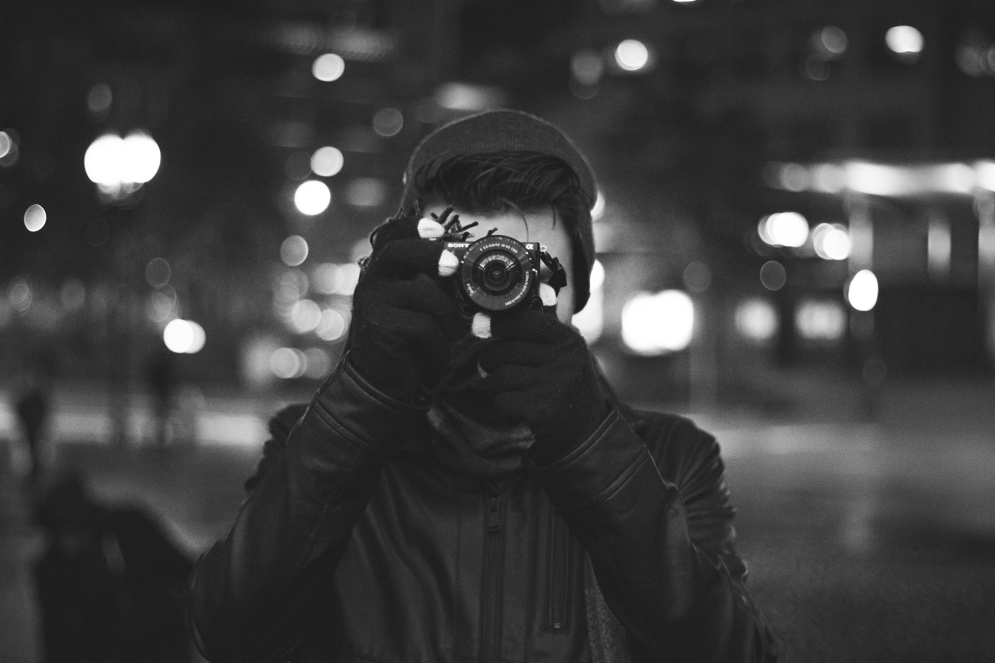 black and white picture of young man taking photo with gloves hat and jacket in boston, point amp shoot 4k, HD Wallpaper