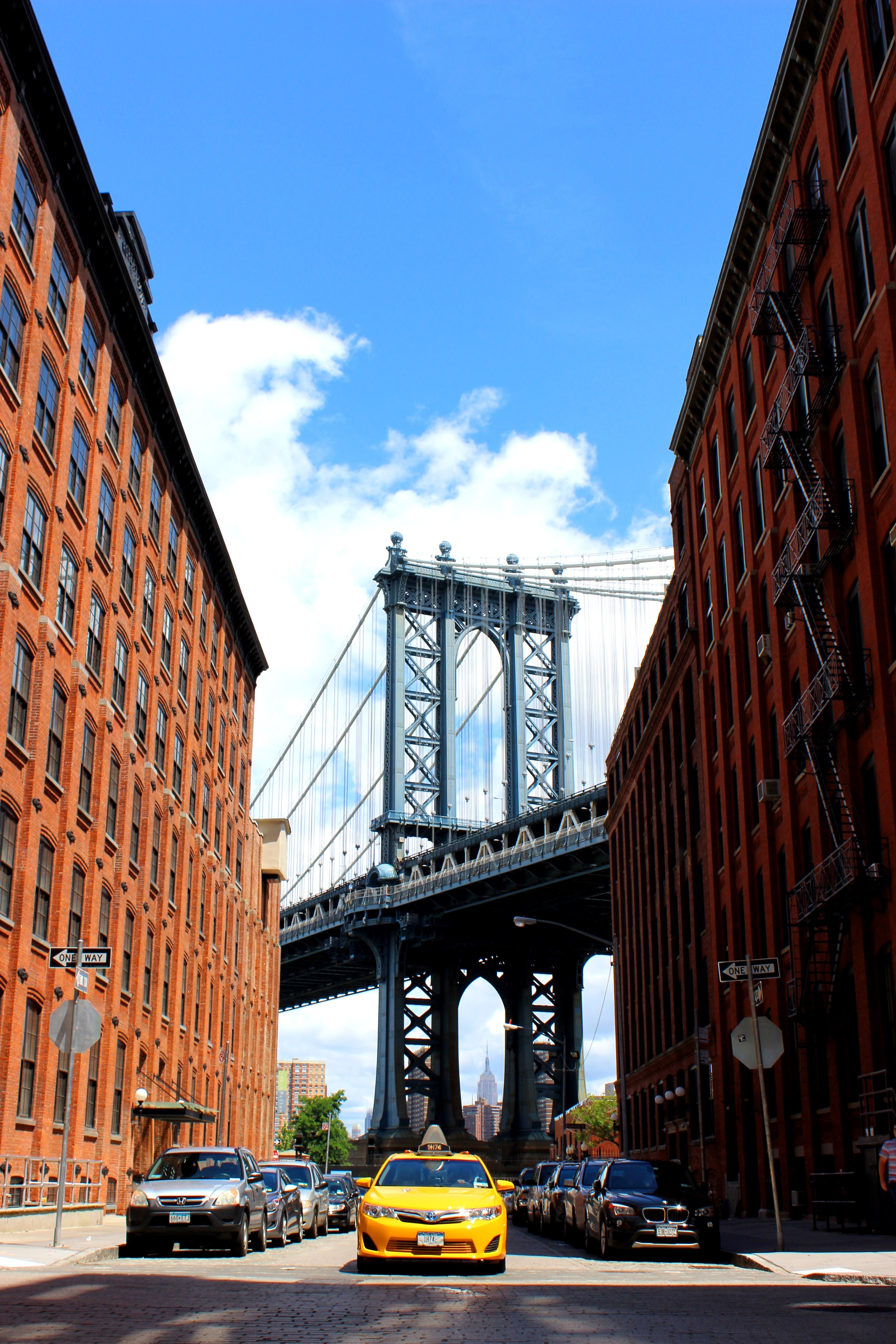 a taxi driving down a new york city street with the manhattan bridge in the background, bright yellow cab 4k, Phone HD Wallpaper