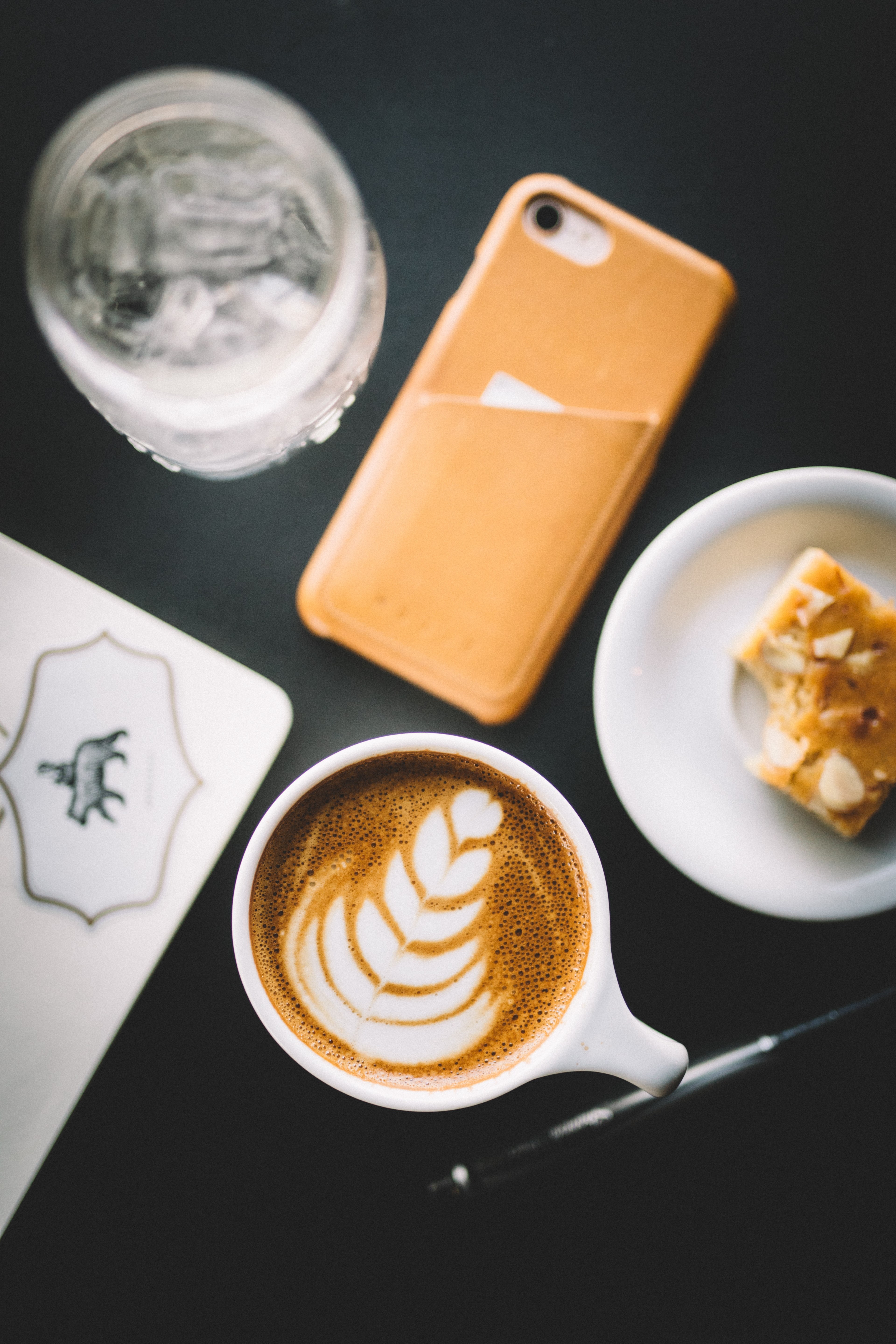an overhead shot of coffee with latte art on it next to a piece of cake and an iphone, coffee art and iphone 4k, Phone HD Wallpaper