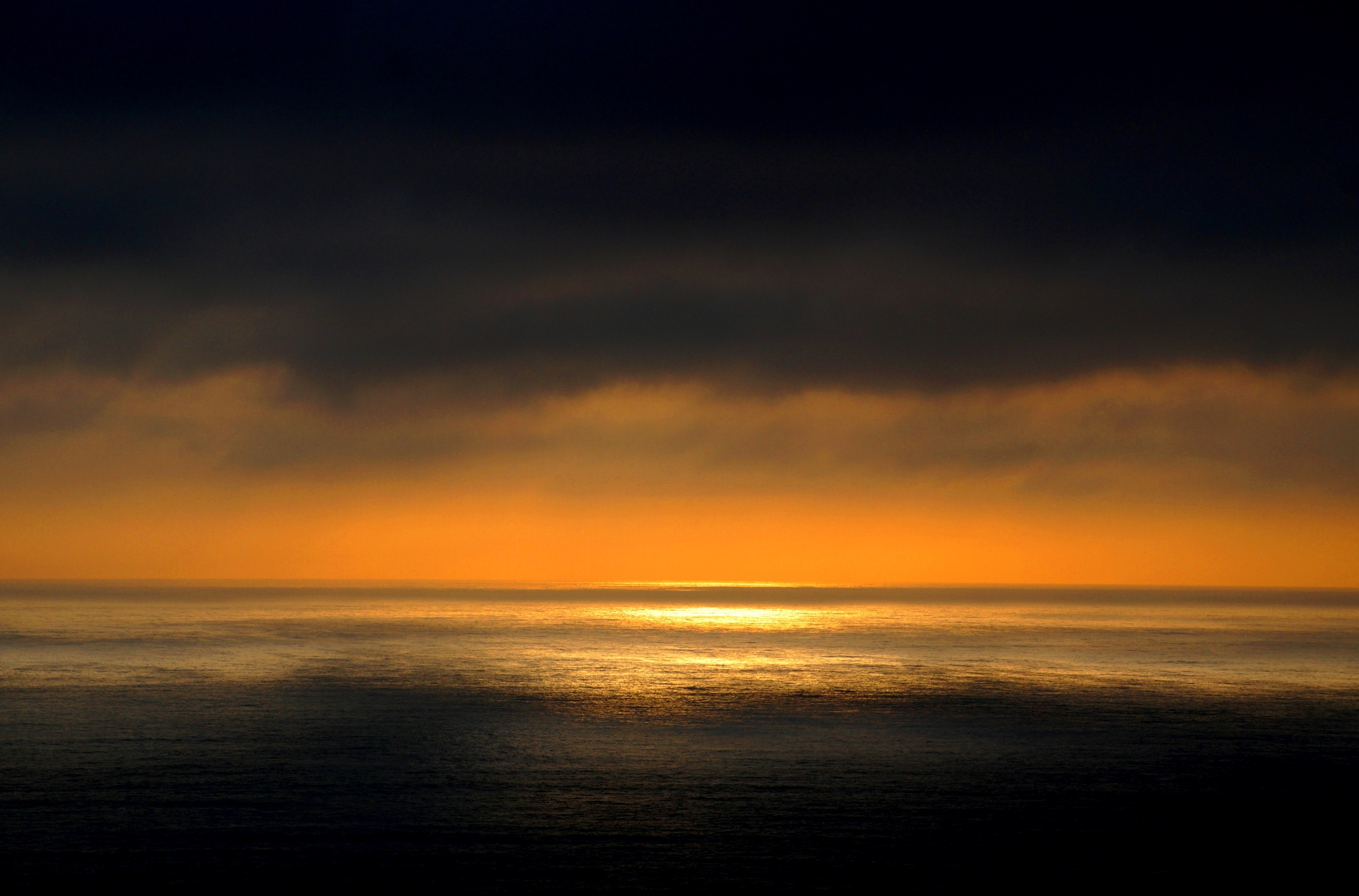 a dark and moody sunset over the ocean with yellow and orange rays on the horizon in chile, chile sunset_ 4k, HD Wallpaper