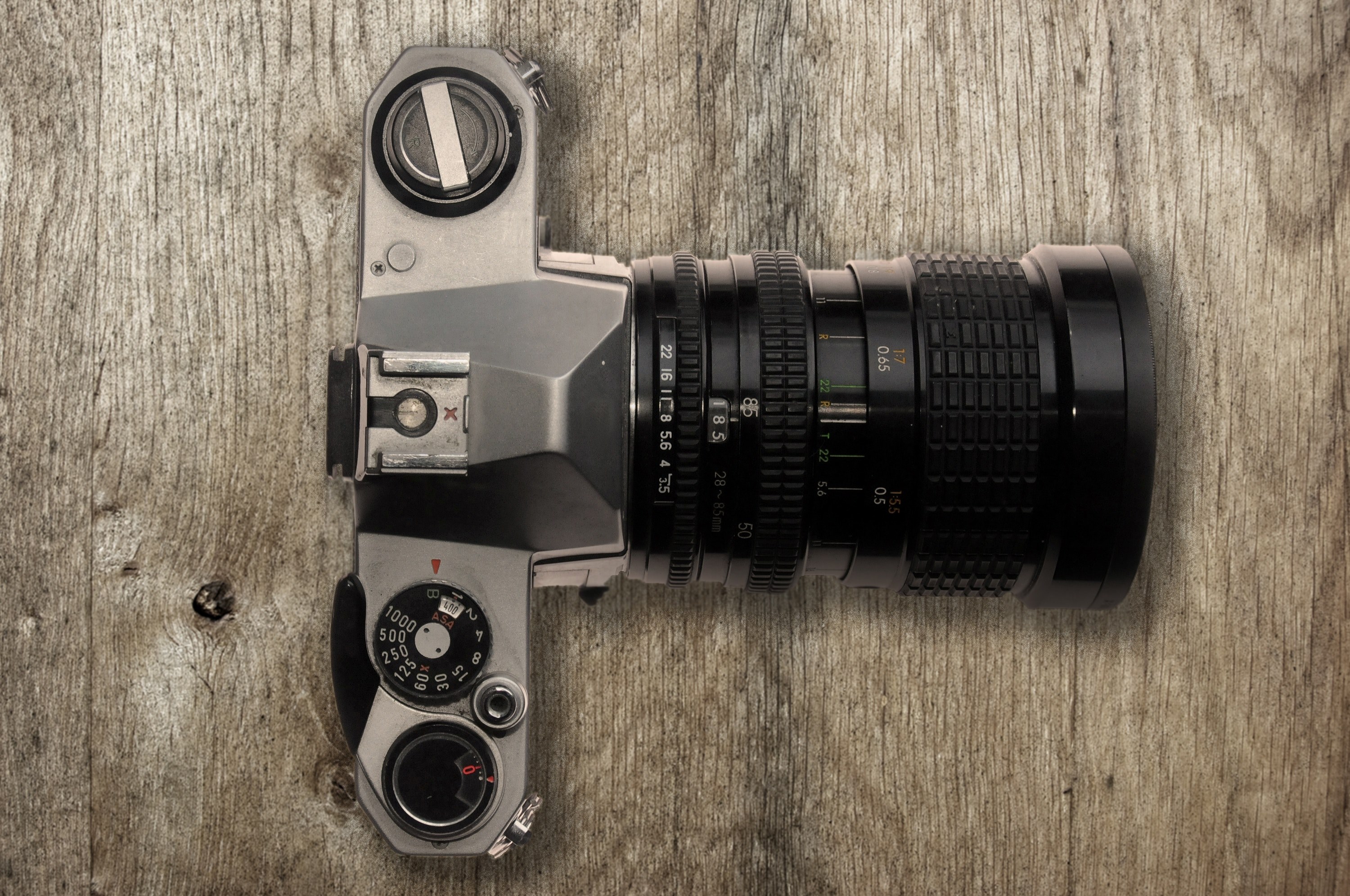 drone view of camera with lens dials and buttons on wooden surface, camera with lens on wood 4k, HD Wallpaper