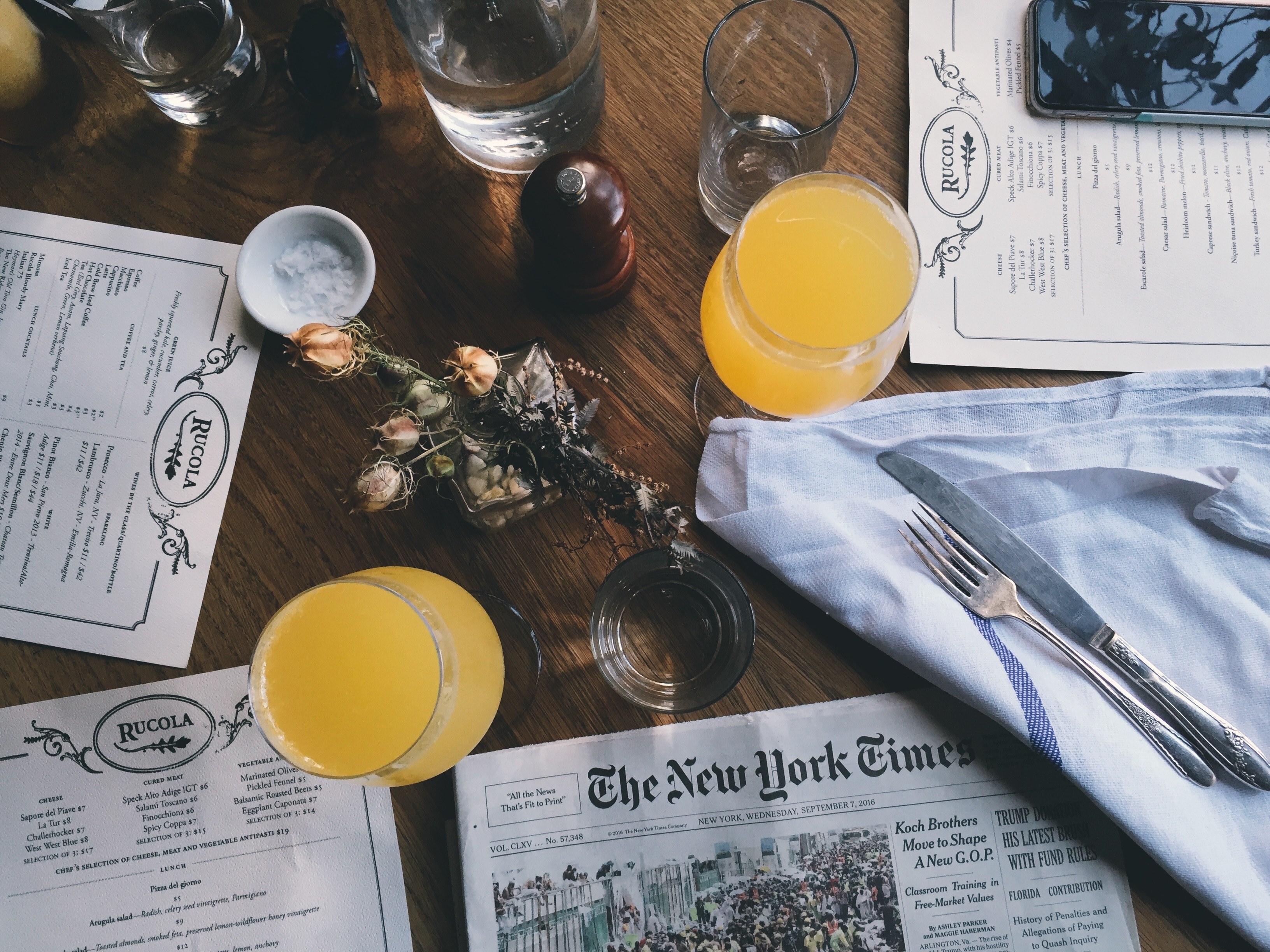 an overhead shot of a restaurant table with glasses of juice and water around a small floral bouquet, top view of a restaurant table 4k, HD Wallpaper